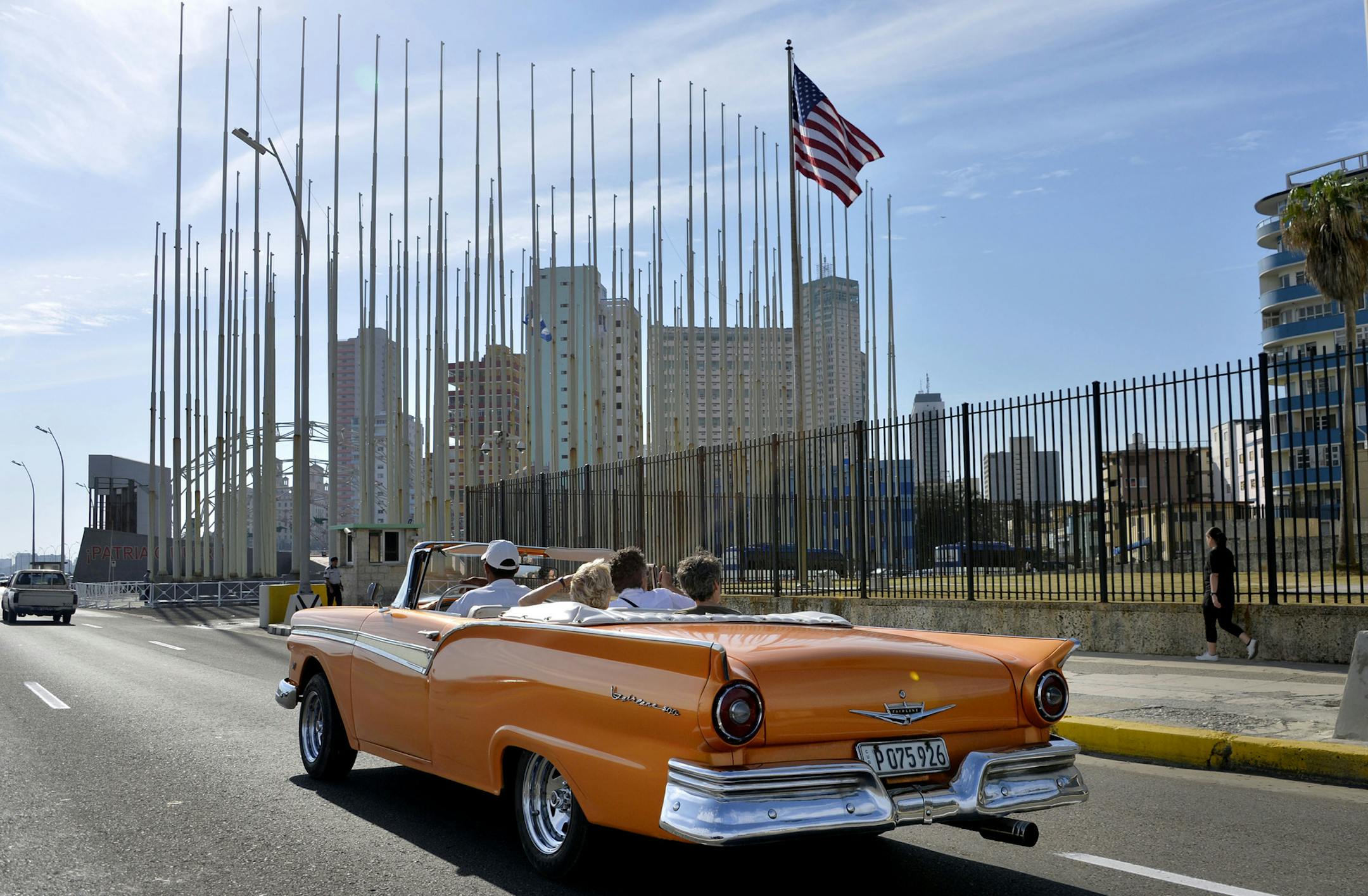 An old car passes in front of the U.S Embassy in Havana, Cuba, on March 17, 2016. (Olivier Douliery/Abaca Press/TNS)