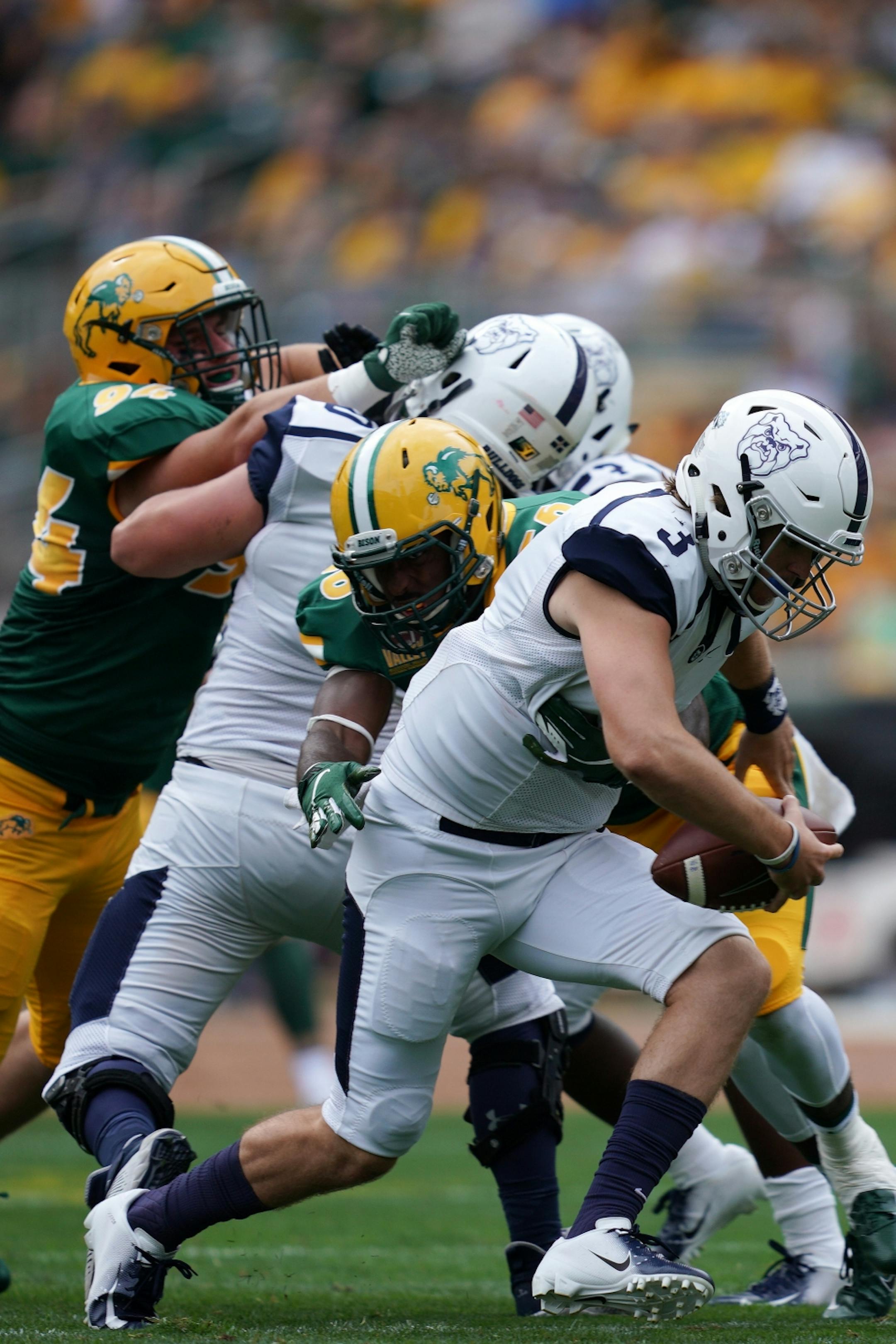 Butler Bulldogs quarterback Sam Brown (3) was brought down by North Dakota State Bison defensive end Justice Kelly (56) as he scrambled with the ball in the first half.