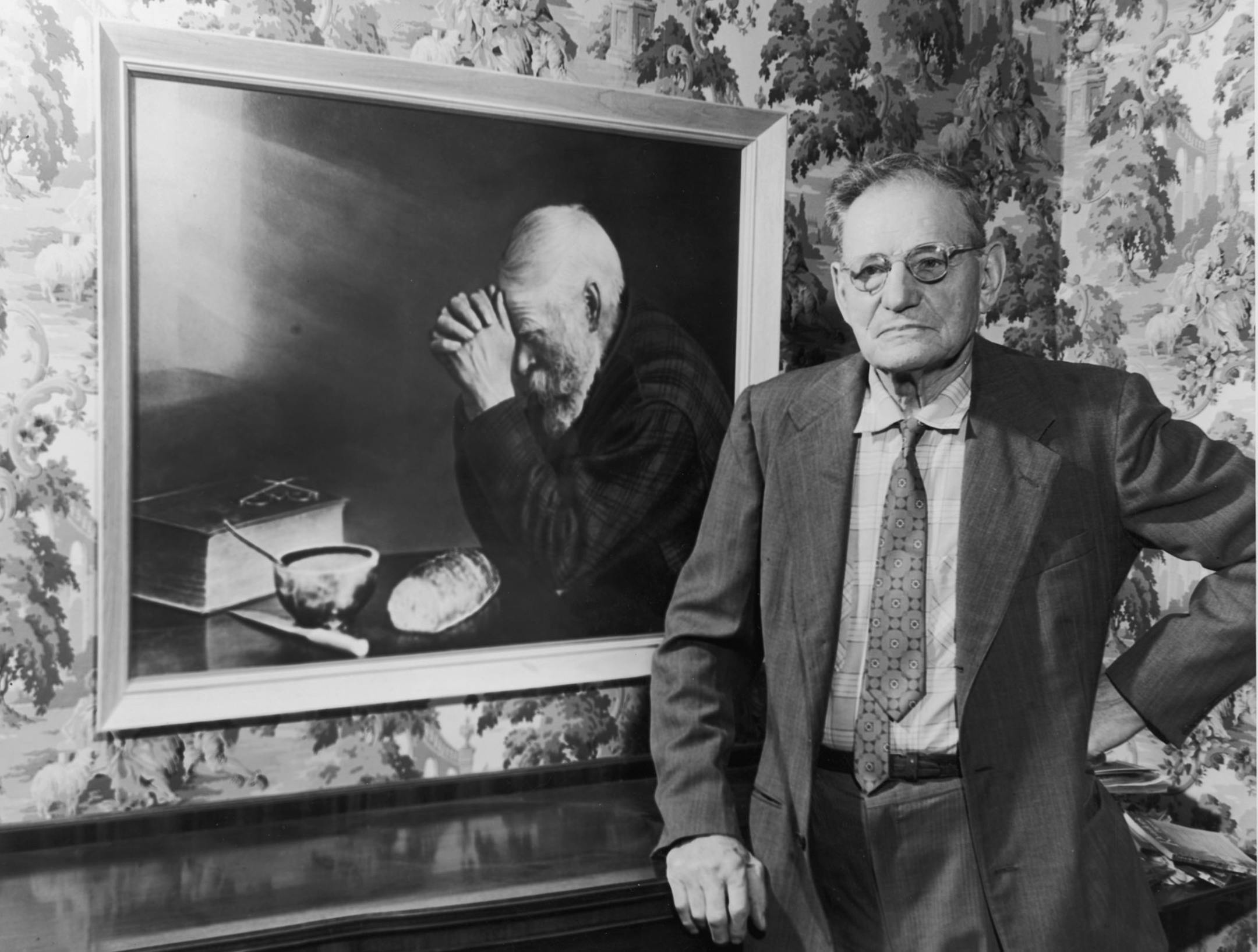 GRACE -- Approx. mid-1950s photo (from book "Ore, Iron and Men") shows photographer Eric Enstrom of Bovey, Minn., with his famous 1918 photo, "Grace." The picture is of Charles Wilden, a peddler from Grand Rapids, Minn. Enstrom's photo was originally printed in sepia tone, but later reproductions added colors, and some appear to be paintings.