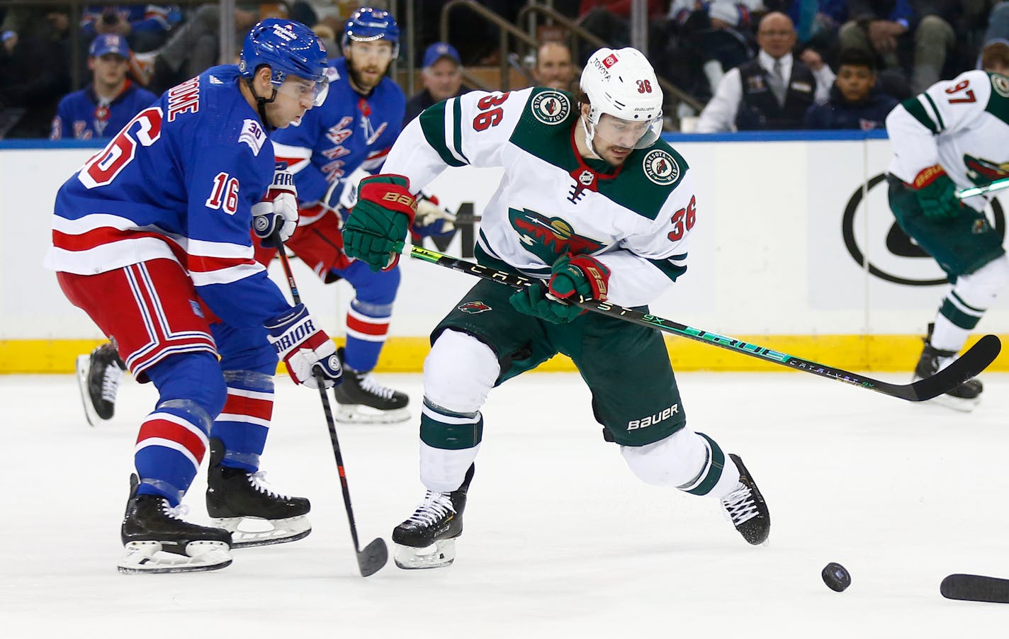 Minnesota Wild's Mats Zuccarello controls the puck in front of New York Rangers' Ryan Strome during the second period Friday night.