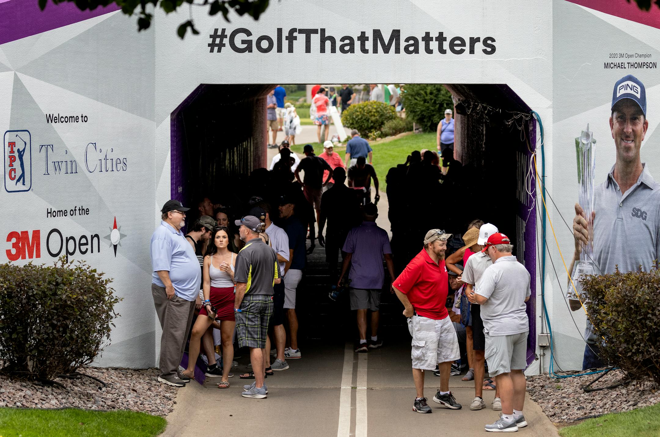 Fans gathered in a tunnel during a weather delay was announced during the first round of the 3M Open in Blaine.