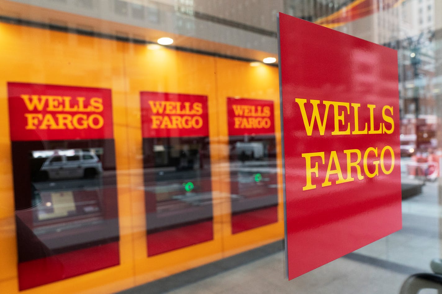 FILE - This Jan. 13, 2021 file photo shows a Wells Fargo office in New York. Wells Fargo &amp; Co. says first-quarter net income jumped to $4.74 billion from $653 million a year earlier, when the pandemic struck the global economy. The San Francisco-based bank said Wednesday, April 14, that it had earnings of $1.05 per share in the latest quarter, compared with a profit of 1 cents a year earlier. (AP Photo/Mark Lennihan, File)