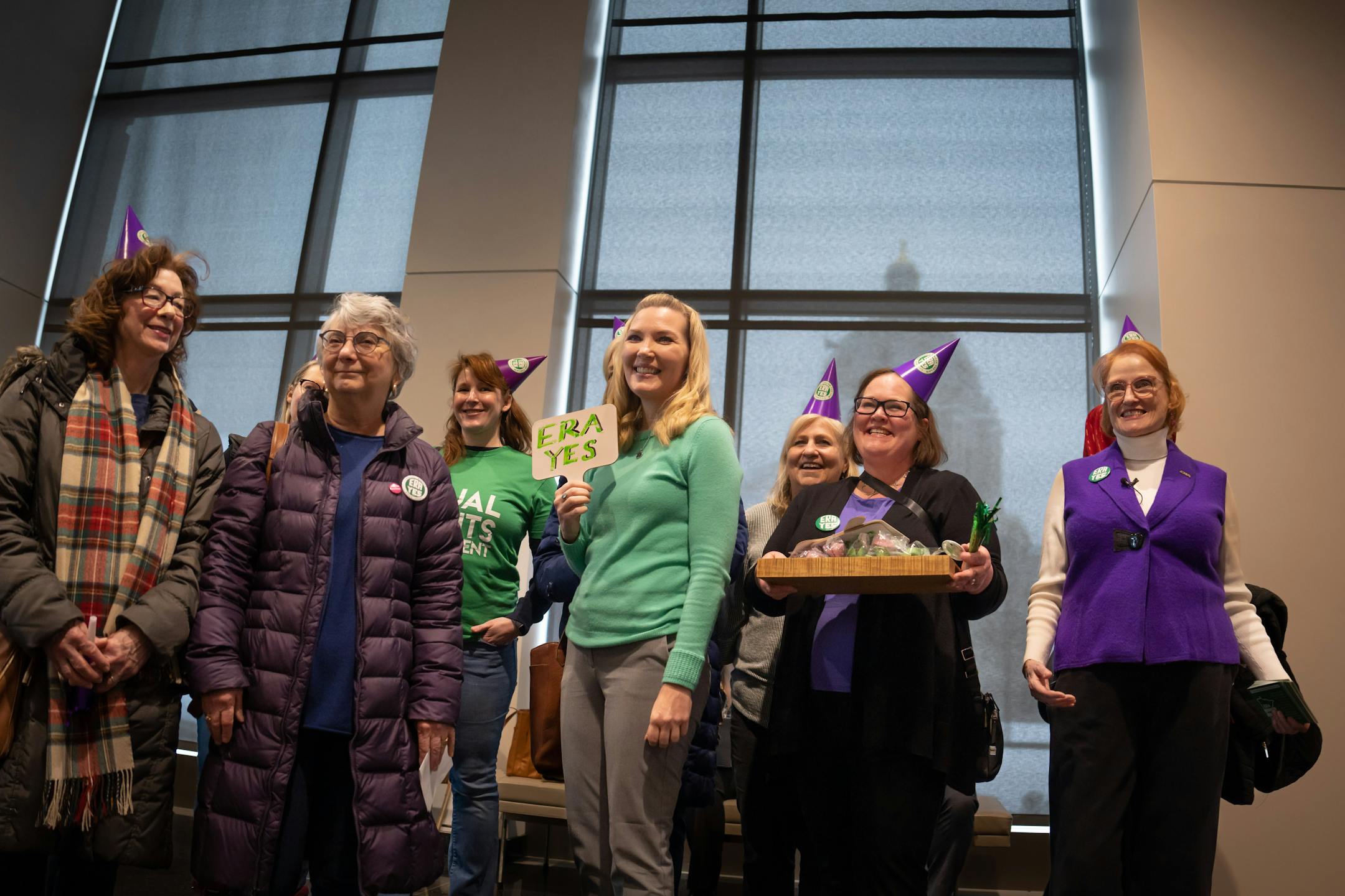 Sen. Nicole Mitchell, DFL-Woodbury, center, posed with a group of ERA backers as they walked around the State Capitol doing an advocacy day.