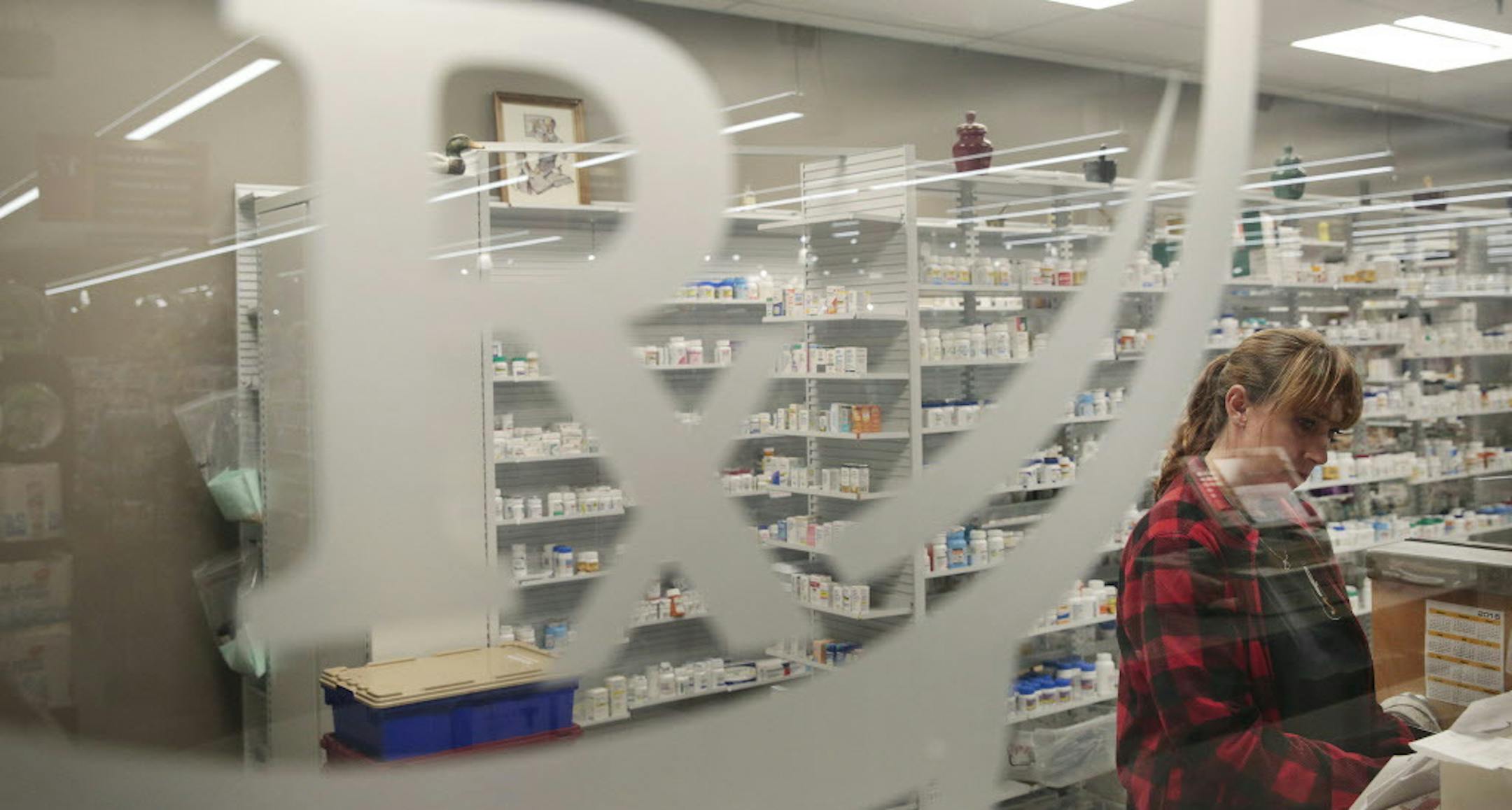 Jody Brady, a pharmacy technician, works at a Raley's supermarket pharmacy in Rohnert Park, Calif., Sept. 17, 2015. The newly concluded Trans-Pacific Partnership trade deal could help decrease prices we see in stores, but not everyone is pleased, especially pharmaceutical companies. (Ramin Rahimian/The New York Times)