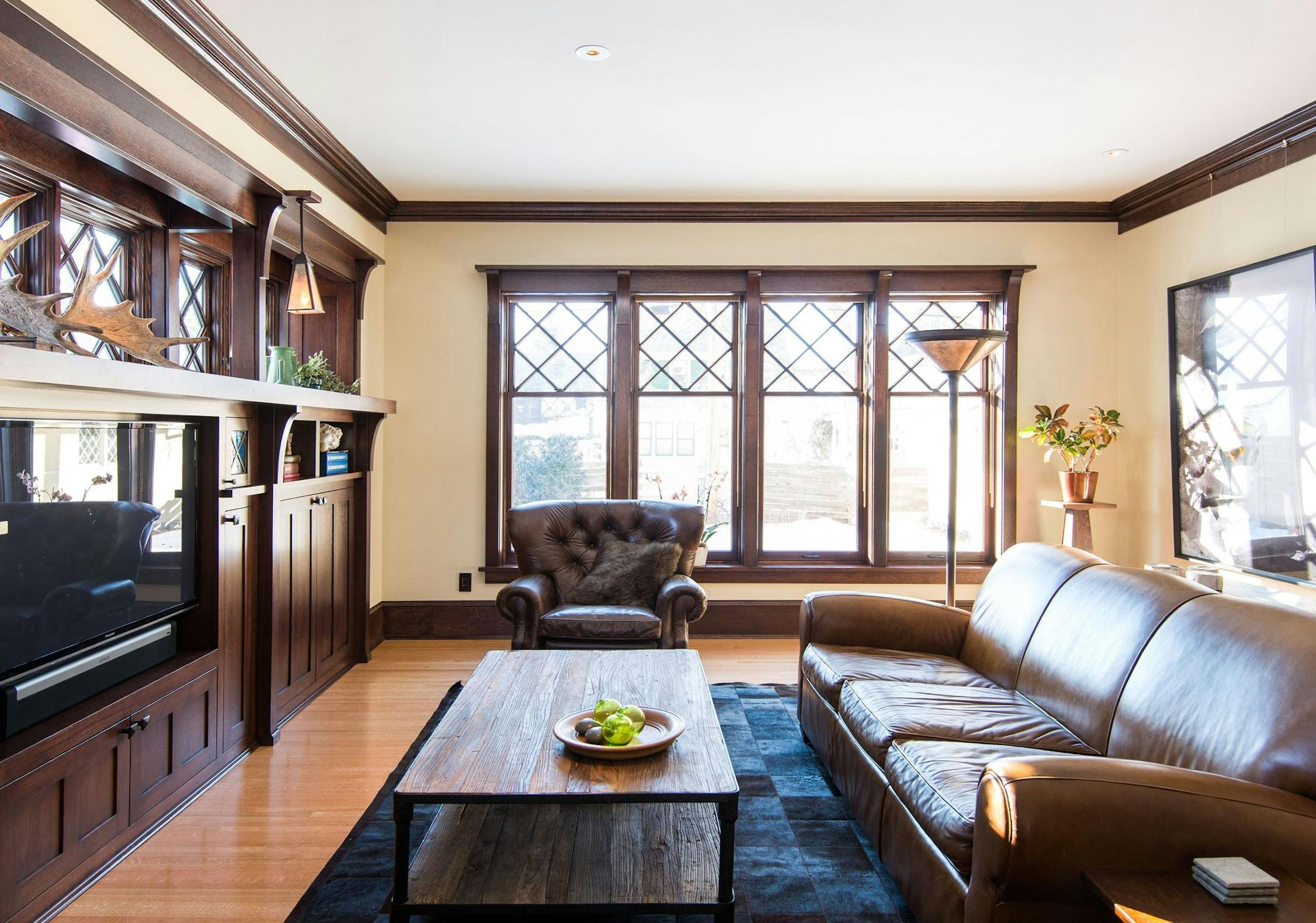 Architect Dan Nepp took design cues from exisiting spaces in his 1911 Craftsman-style home, above, such as the diamond-pane windows, for his seamless family room addition.