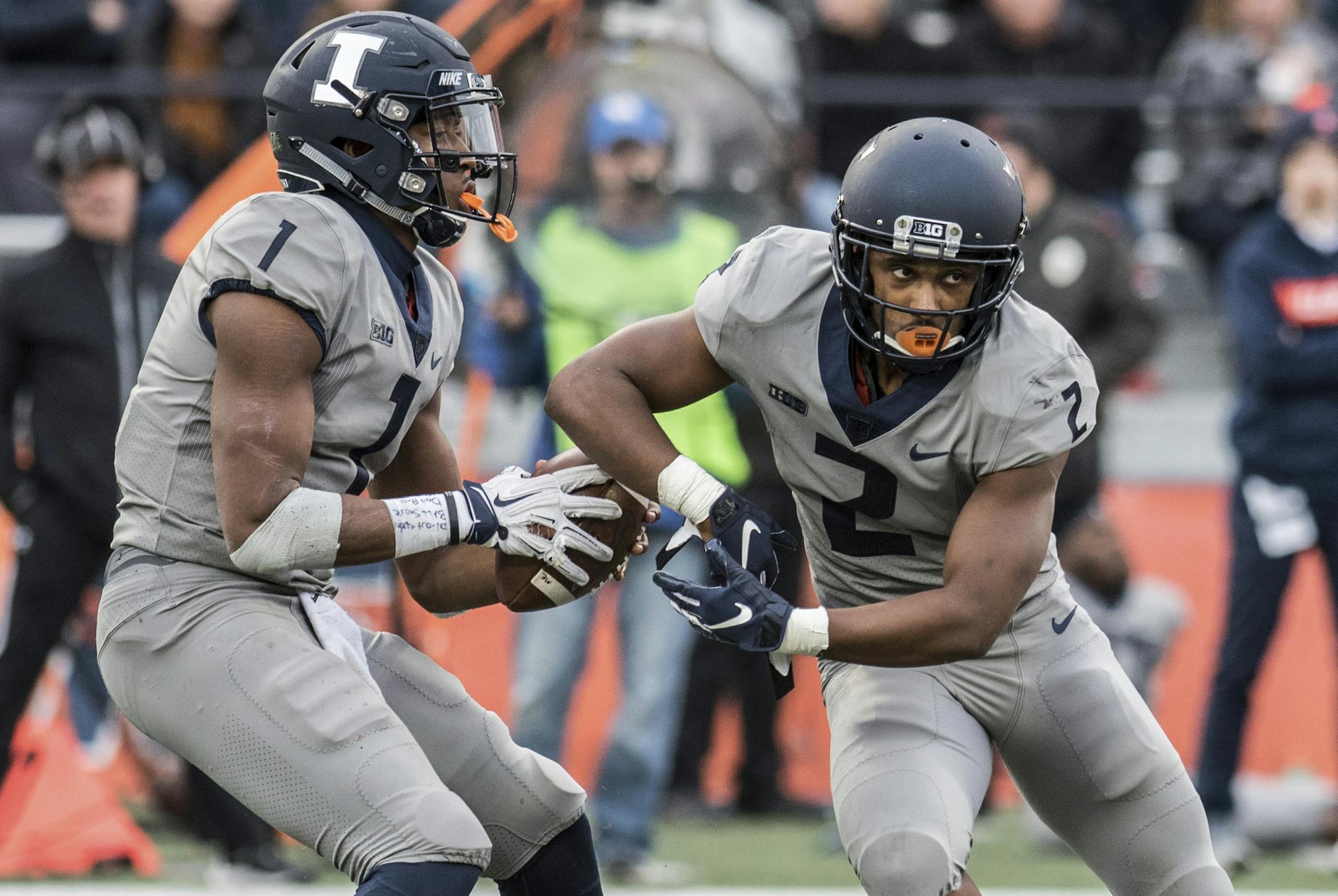 Illinois quarterback AJ Bush, Jr. (1) fakes the handoff to running back Reggie Corbin (2) in the second half of an NCAA college football game against Purdue, Saturday, Oct. 13, 2018, in Champaign, Ill. (AP Photo/Holly Hart)