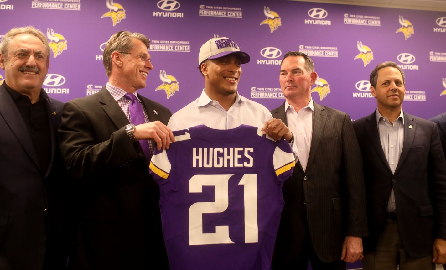 Vikings first round pick cornerback Mike Hughes from Central Florida, surrounded by Zygi Wilf, Vikings owner, left to right, Vikings general manager Rick Spielman, Vikings head coach Mike Zimmer, and Mark Wilf