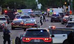 Investigators examine the scene of a shooting that killed a Minneapolis police officer, civilian, suspect and wounded others Thursday, May 30, 2024, i