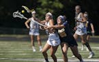 Prior Lake High School's Josie Kropp (8) struggled for the ball with Breck School's Polly Burns (25) during the first half of the Girls Lacrosse State