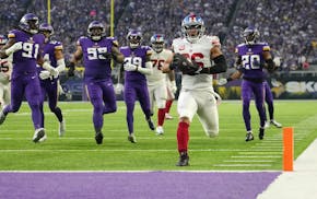 New York Giants running back Saquon Barkley (26) scores a touchdown in the first quarter of an NFL wild card playoff game between the Minnesota Viking