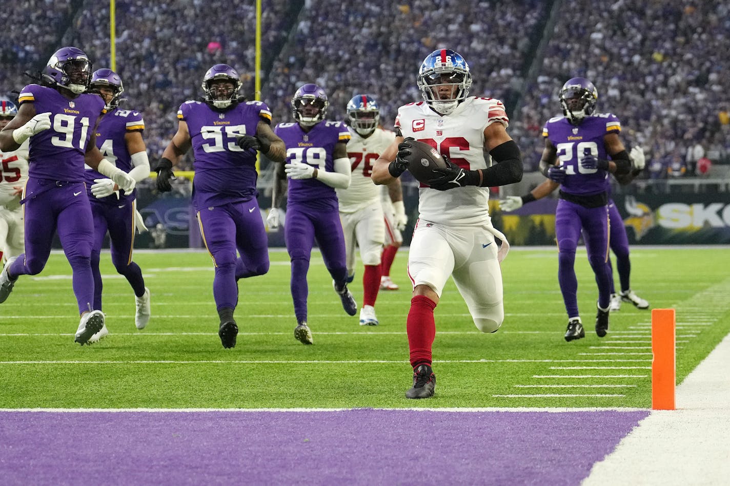 New York Giants running back Saquon Barkley (26) scores a touchdown in the first quarter of an NFL wild card playoff game between the Minnesota Vikings and the New York Giants on Sunday, Jan. 15, 2023 at U.S. Bank Stadium in Minneapolis. ] ANTHONY SOUFFLE • anthony.souffle@startribune.com