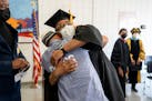 Walter L. McCoy Jr. hugs a student in the Goucher Prison Education Partnership after the Goucher College graduation ceremony at the Maryland Correctio