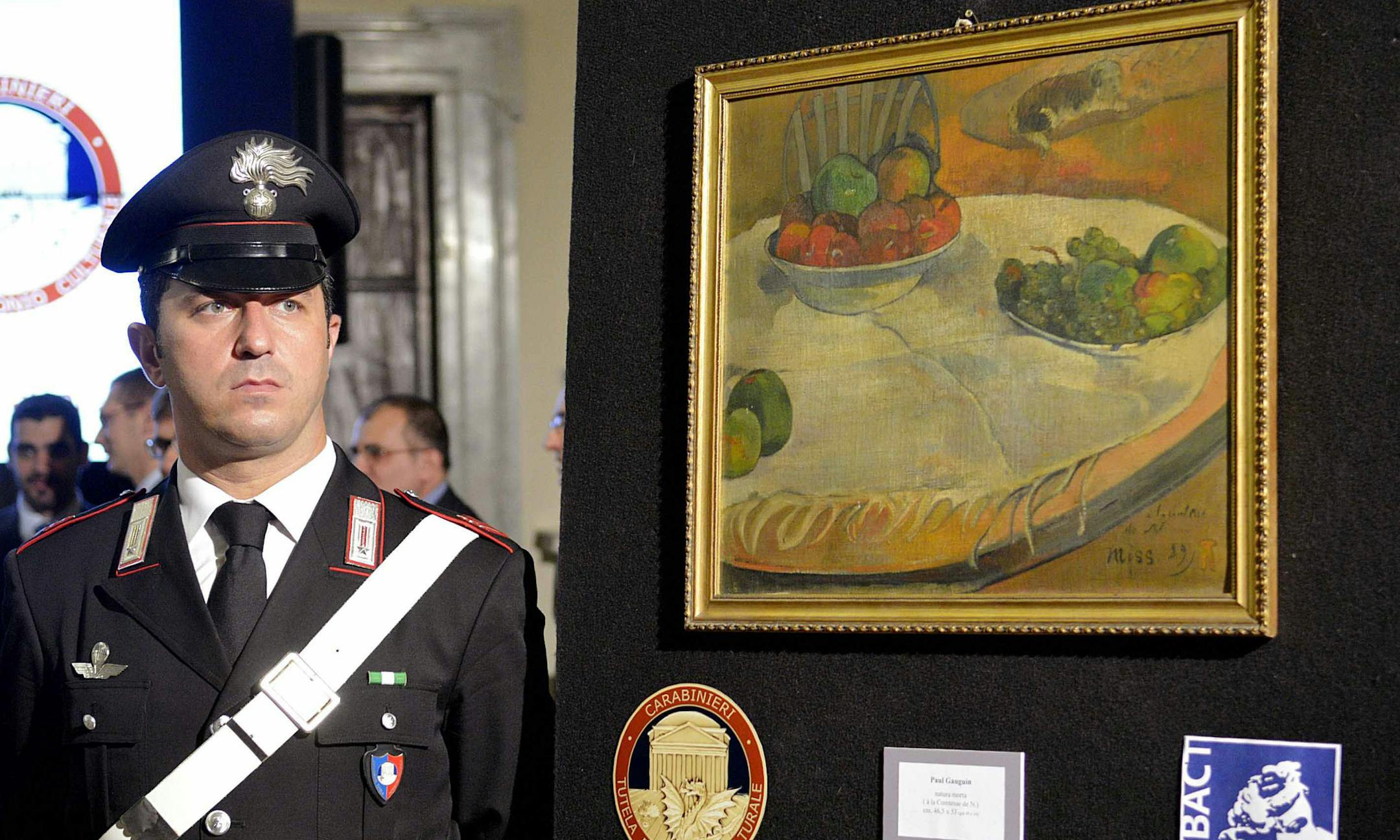 A carabiniere (Italian paramilitary police) officer stands by a Paul Gauguin still life recovered by authorities, during a press conference in Rome, Wednesday, April 2, 2014. Italian police say a Paul Gauguin still life, stolen from a private collection in Britain in 1970, hung on a kitchen wall in a retired Sicilian auto-worker's home for 40 years but now has been recovered by authorities. Maj. Massimiliano Quagliarella of the paramilitary Carabininieri art theft squad told The AP Wednesday the