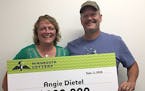 Angie Dietel claimed her prize Tuesday at State Lottery headquarters in Roseville, with husband David at her side. Credit: Minnesota Lottery