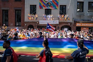 A unit passes the Stonewall Inn with a rainbow banner during the LBGTQ Pride march Sunday, June 30, 2019, in New York. 