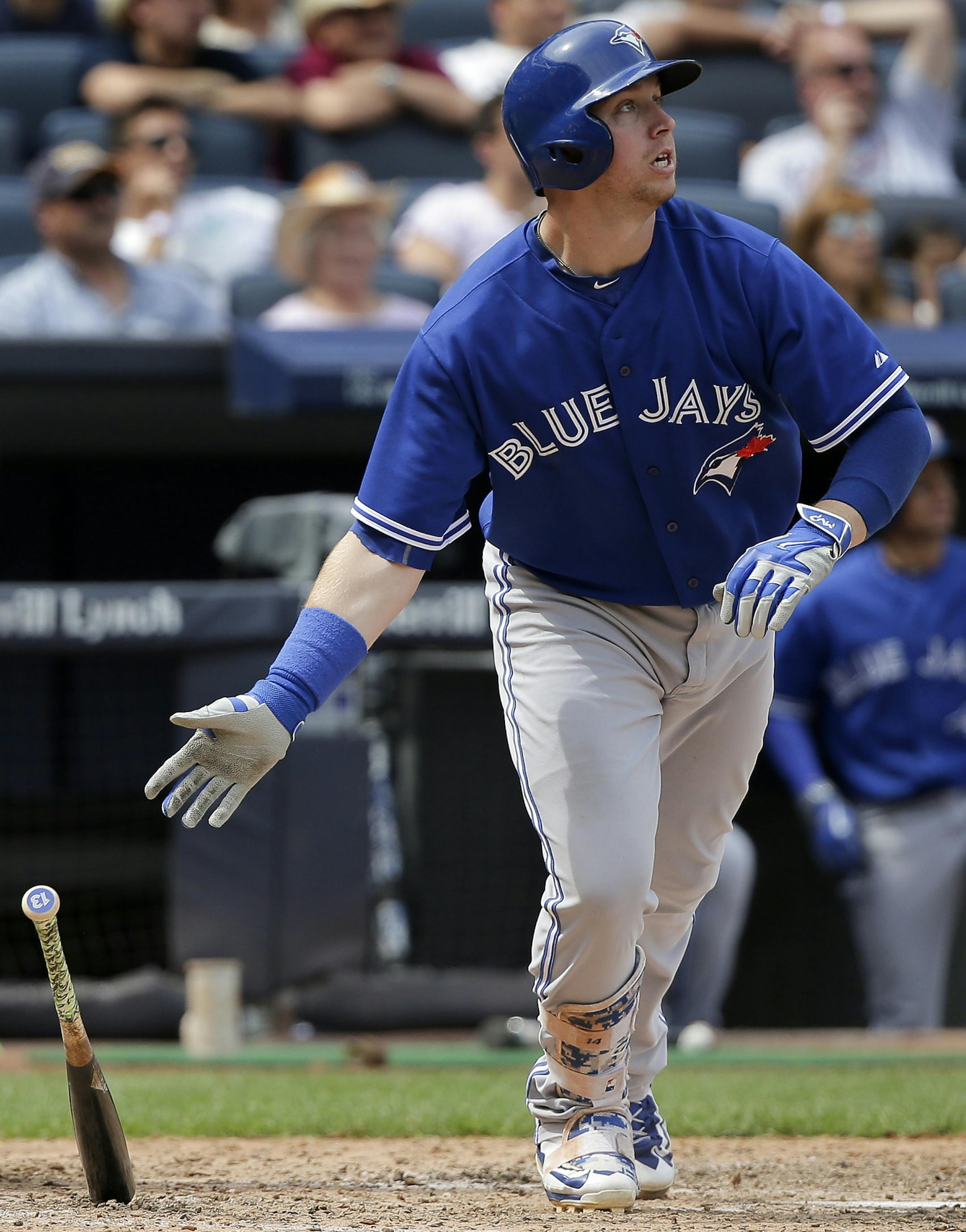 Toronto Blue Jays' Justin Smoak drops his bat after connecting for a grand slam home run as New York Yankees catcher Brian McCann watches during the sixth inning of a baseball game, Saturday, Aug. 8, 2015, in New York. (AP Photo/Julie Jacobson)