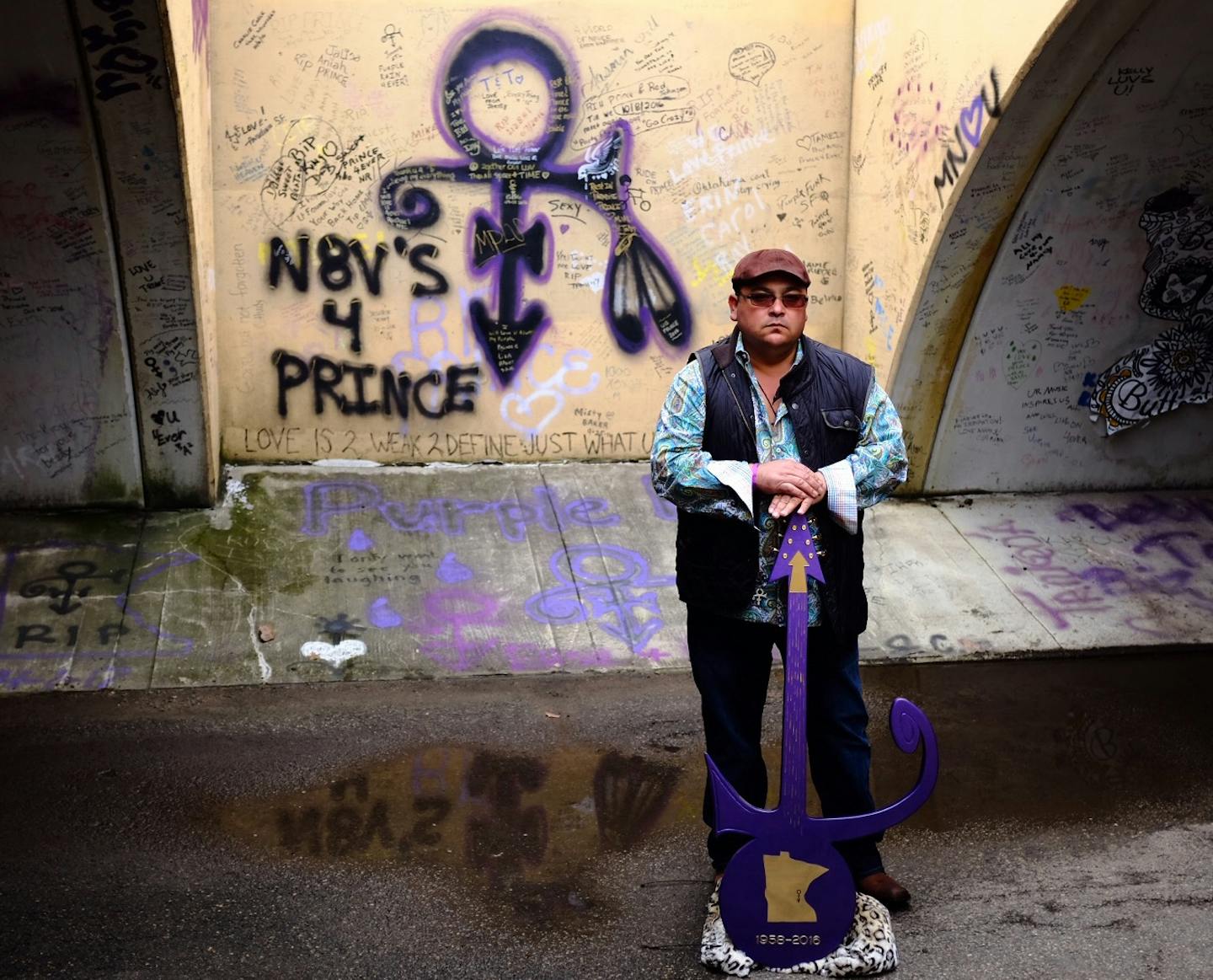 Nick Garcia, of San Angelo, Texas, stood for a portrait in the Graffit tunnel outside of Prince's Paisley Park on Thursday, April 20, 2017. He was holding a custom guitar he built, "Minnesota Golden Hero." ] Aaron Lavinsky/Star Tribune