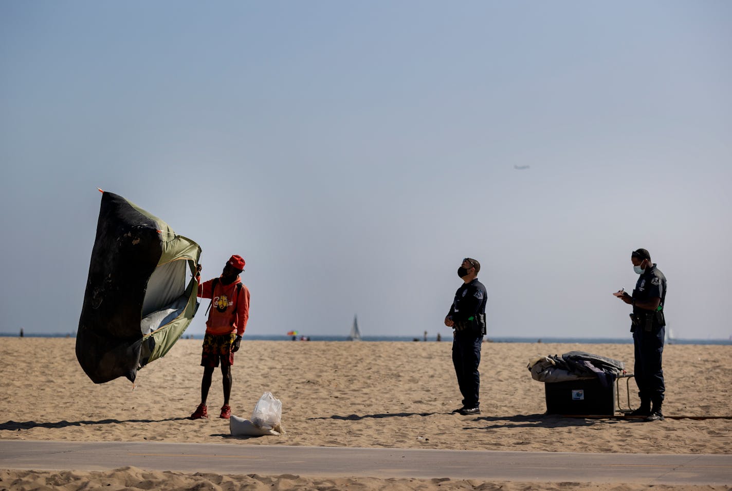 Fredrick Teal a homeless man folded up his tent after being cited by police for being on Venice Beach.