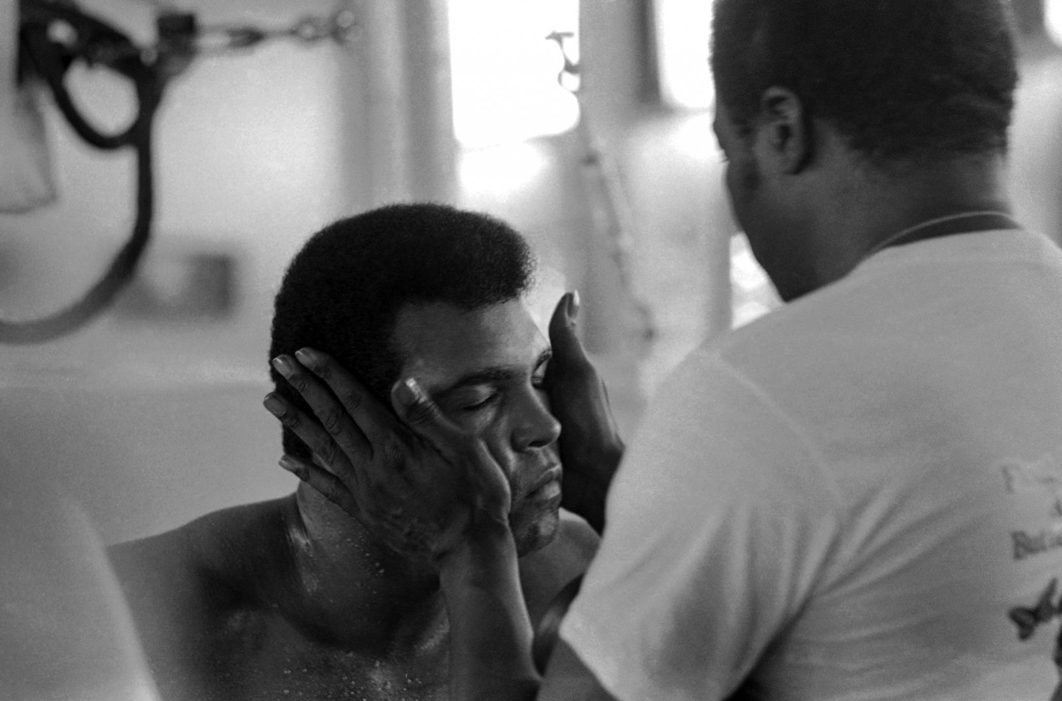 Muhammad Ali closes his eyes as his trainer massages his head after first workout at the gym at the N?Sele training camp in Kinshasa, Zaire, Sept. 11, 1974. (AP Photo/Horst Faas) ORG XMIT: APHS280848