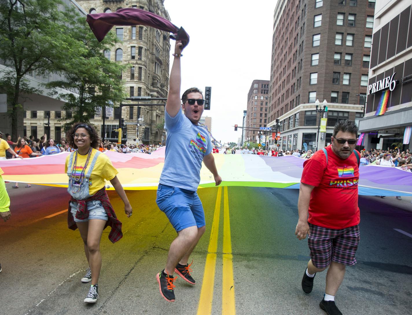 People carrying the pride flag at the helm of the parade get excited as they try to get the crowd cheering during the parade on Sunday. ] ALEX KORMANN &#x2022; alex.kormann@startribune.com Hundreds of thousands of people gathered on Hennepin Avenue for the annual Pride Parade on Sunday. People of all age, shapes and sizes lined the street to celebrate love and all it's forms. Dozens of local businesses and organizations marched in the parade, all showing support for the LGTBQ community.