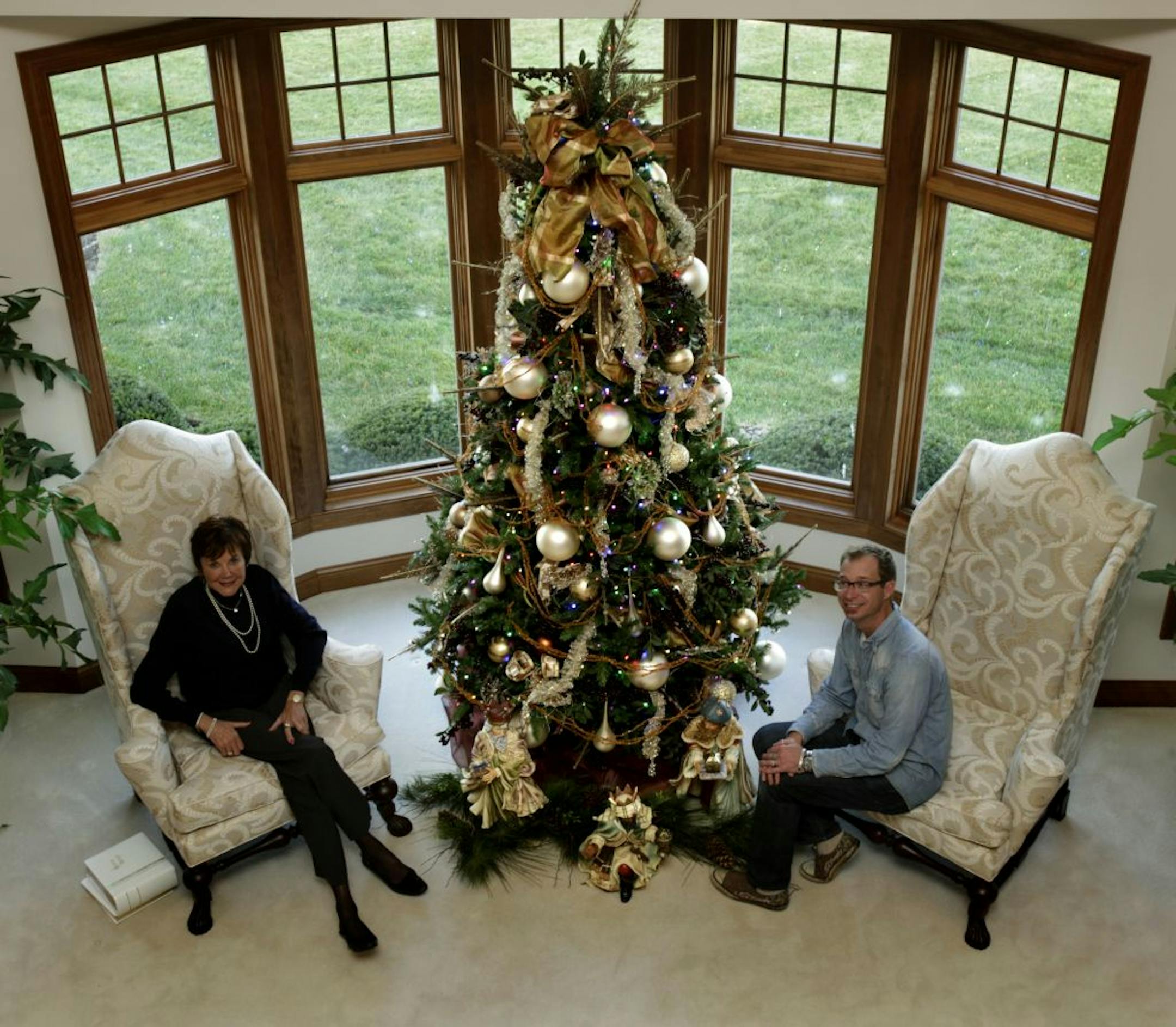 Kathy Putrah, left, celebrates Christmas with 10 themed trees. In her living room, Bachman's designer Scott Ellingboe combined her existing ball and berry ornaments with new feathered fans and champagne netting.