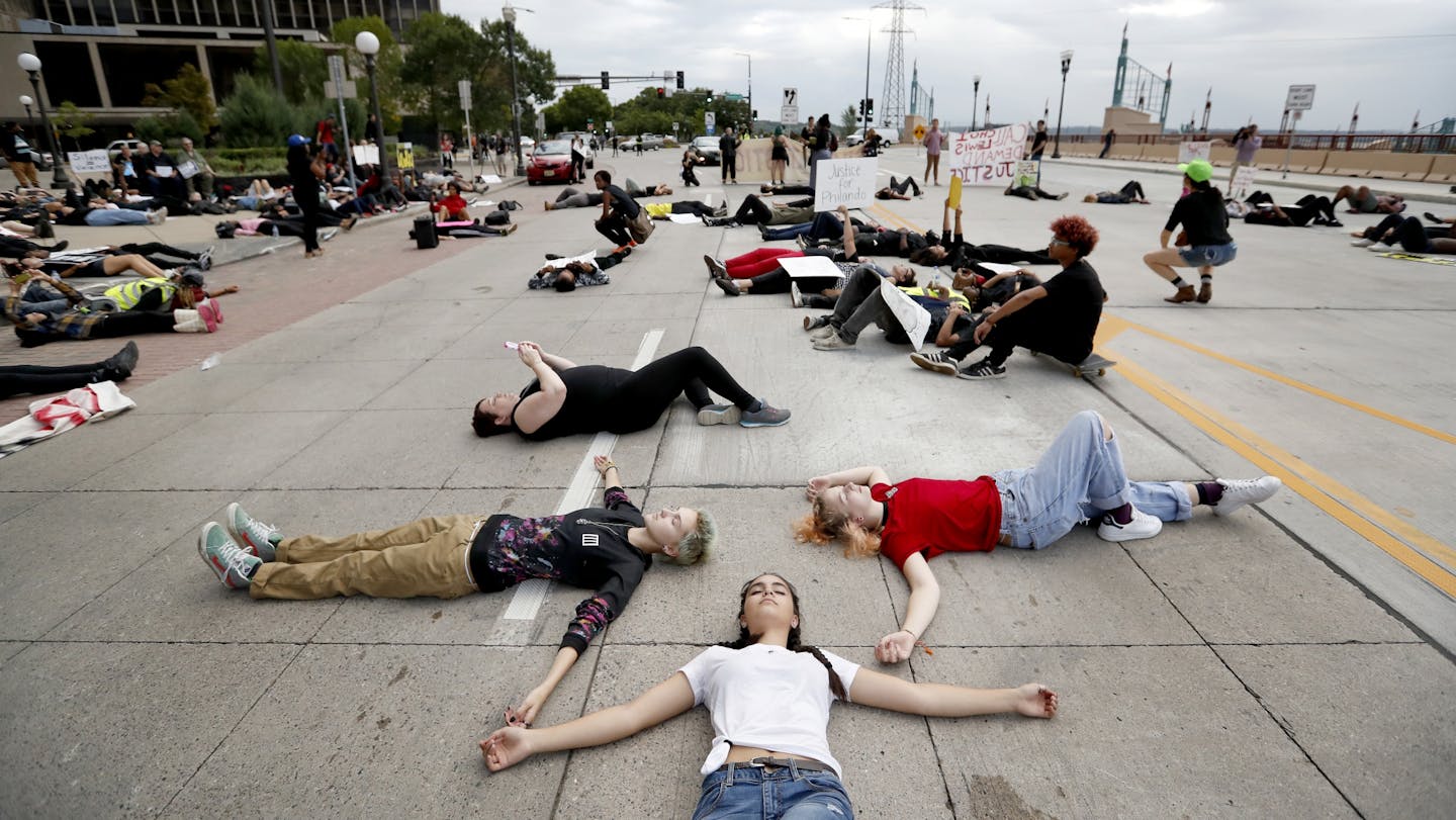 Protesters lay down on Kellogg Blvd. in St. Paul on Tuesday.