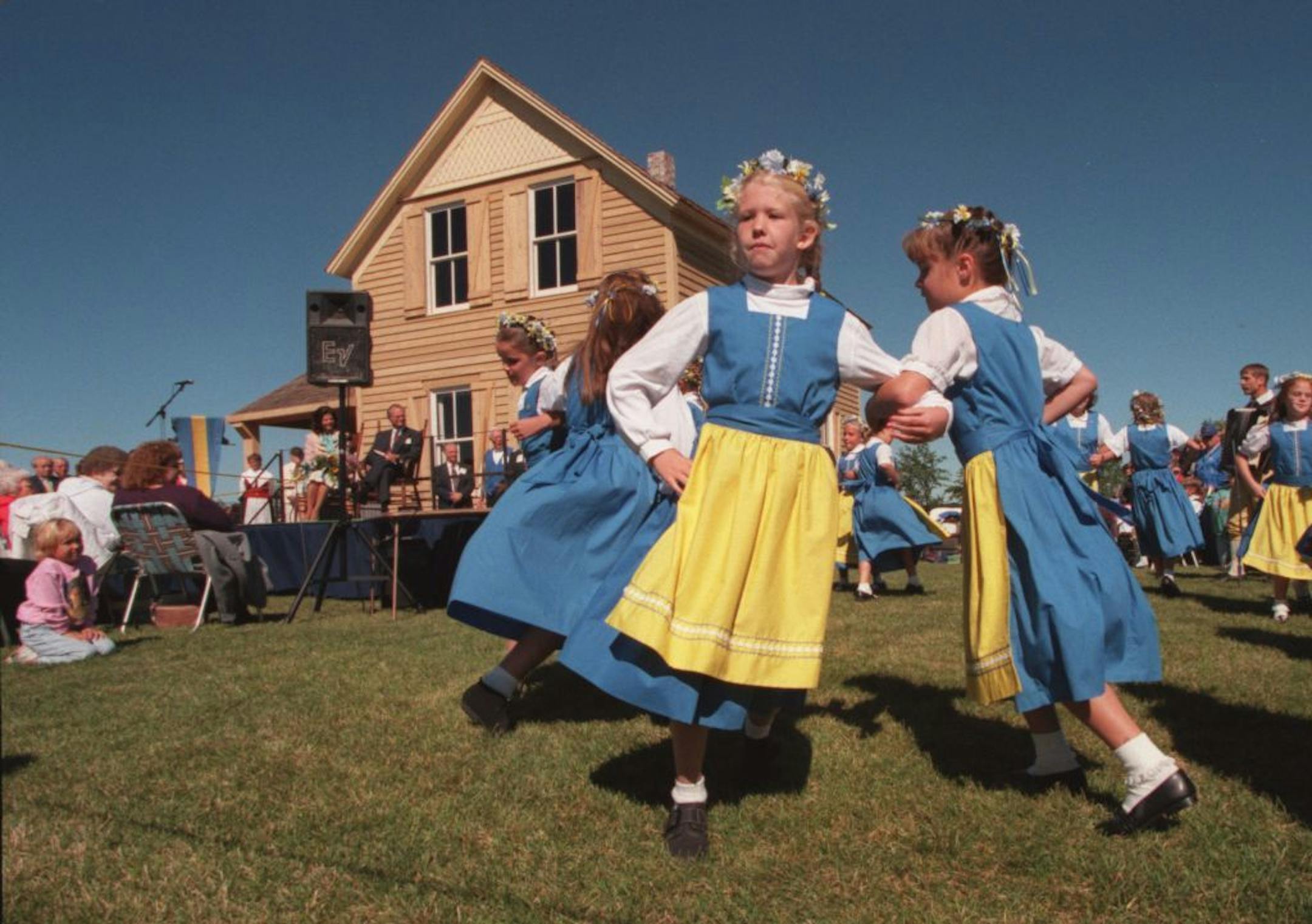 -- dance.3269,- children in folk dress - the Kichi-Saga Junior Dancers danced in for the King and Queen as they sat in front of the restored farmhouse -the Nya Duvemala- the ficticious home of Karl Oskar in a Moberg story- near Lindstrom MN