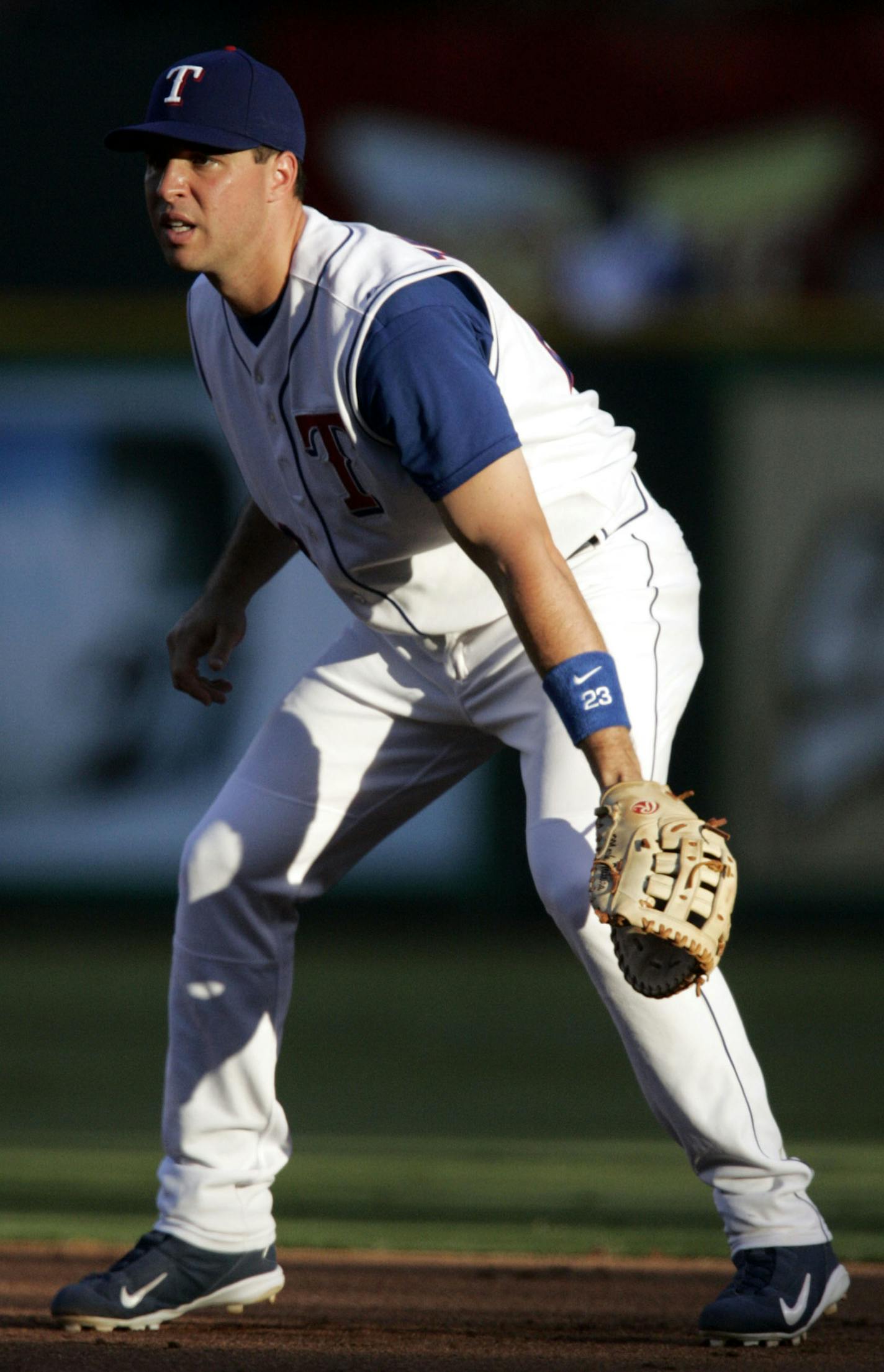 The setting sun cast shawdows across Texas Rangers first baseman Mark Teixeira in the second inning against the Seattle Mariners in a baseball game in Arlington, Texas, Thursday, Aug. 10,2006. The Rangers won 8-2. (AP Photo/Tony Gutierrez) ORG XMIT: OTKTG103