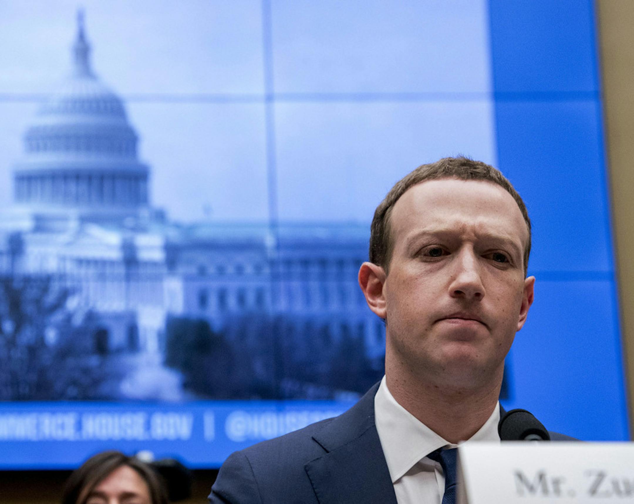 FILE - In this April 11, 2018, file photo, Facebook CEO Mark Zuckerberg pauses while testifying before a House Energy and Commerce hearing on Capitol Hill in Washington about the use of Facebook data to target American voters in the 2016 election and data privacy. Zuckerberg is calling for more outside regulation in several areas in which the social media site has run into problems over the past few years: harmful content, election integrity, privacy and data portability. (AP Photo/Andrew Harnik