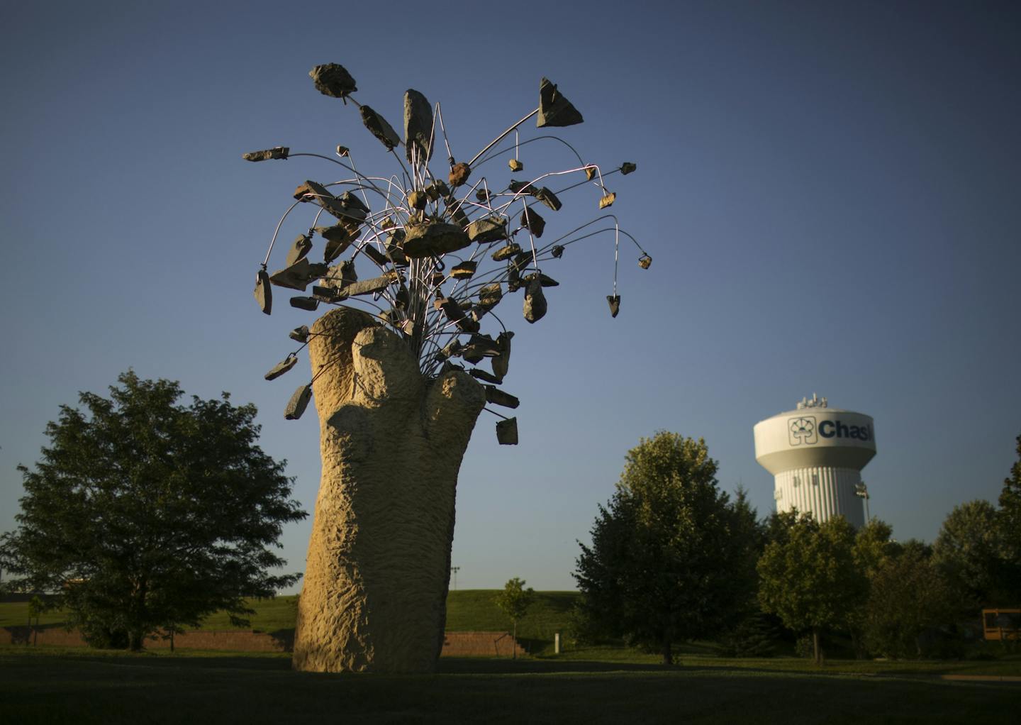 "Nature Morte" by Minneapolis artist Zoran Mojsilov in Chaska Wednesday night. ] JEFF WHEELER &#xef; jeff.wheeler@startribune.com A dozen years after it landed in Chaska, "Nature Morte" still causes a ripple. The large abstract concrete and metal sculpture cost the city $23,000 and some complain that it's out of place in a conventional suburban subdivision. the piece, installed in Chaska in 2003, was photographed Wednesday evening, July 29, 2015.