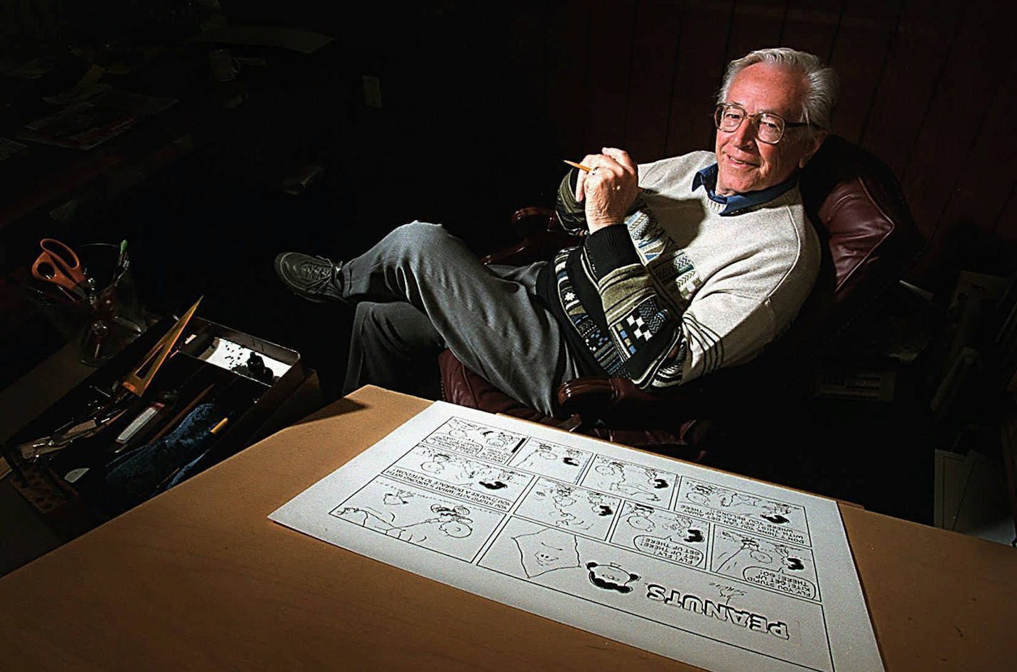 Peanuts creator Charles Schulz will celebrate his 75th birthday on Wednesday, Nov. 26, with his first vacation in 47 years of drawing the strip, one of which is shown at his desk in Santa Rosa, Calif., on Nov. 20, 1997. Charlie Brown and Snoopy will be in reruns for five weeks for the first time since their creation. (AP Photo/The Press Democrat, John Burgess) ORG XMIT: CASRP102