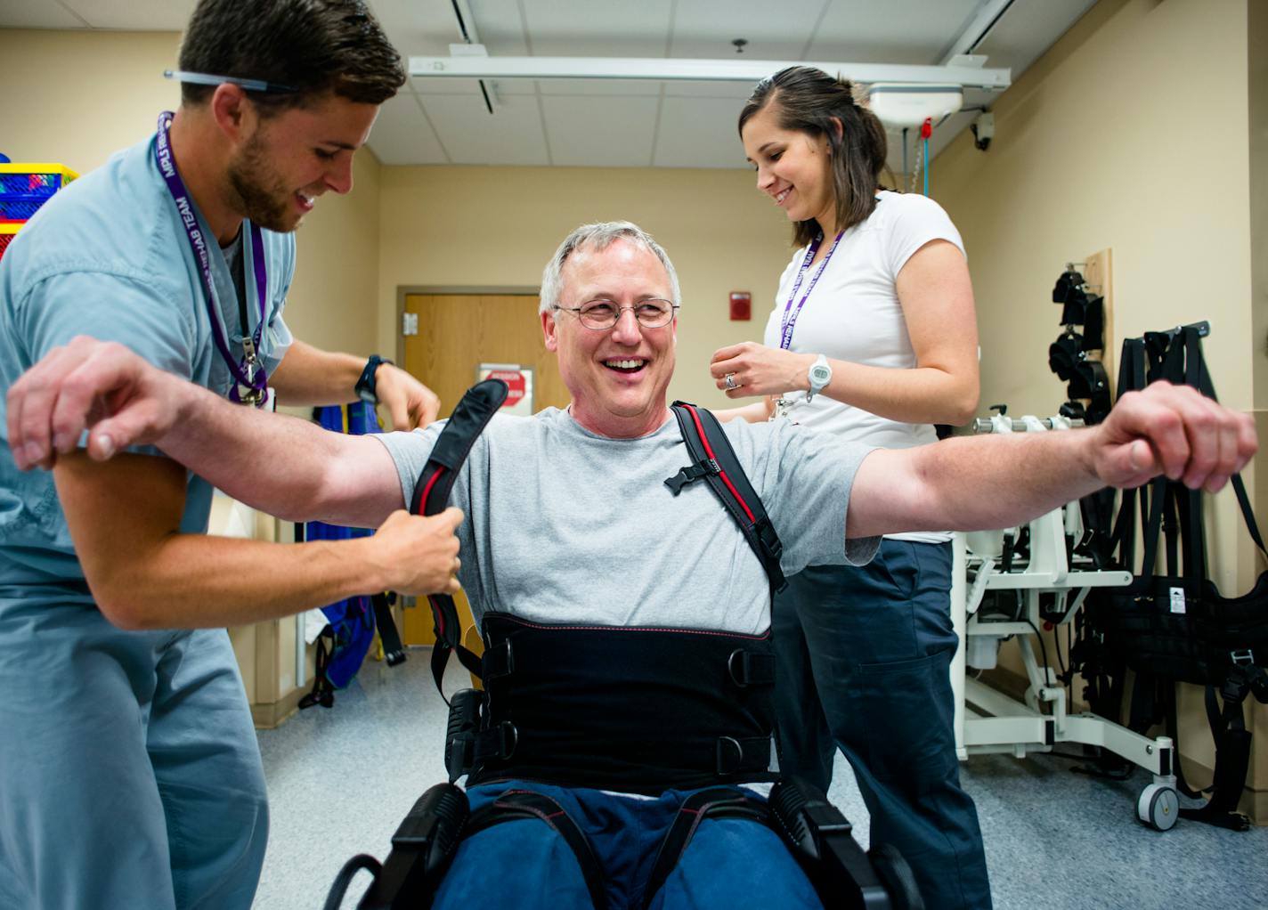 Physical therapists Ryan Bouslog left, and Elizabeth Koch, strapped Doug Eckhoff into the Esko GT. ] Mark Vancleave - mark.vancleave@startribune.com * Doug Eckhoff, of Victoria, Minn., undergoes physical therapy treatments twice a week at the Minneapolis VA. Eckhoff is learning to walk again after suffering a partial spinal cord injury in a motorcycle accident with an exoskeleton made by Ekso Bionics. Photographed on Thurs., May 26, 2016.