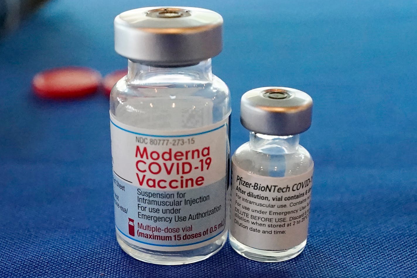 FILE - This Sept. 21, 2021 file photo shows vials of the Pfizer and Moderna COVID-19 vaccines in Jackson, Miss. Billions more in profits are at stake for some vaccine makers as the U.S. moves toward dispensing COVID-19 booster shots to shore up Americans' protection against the virus. (AP Photo/Rogelio V. Solis)