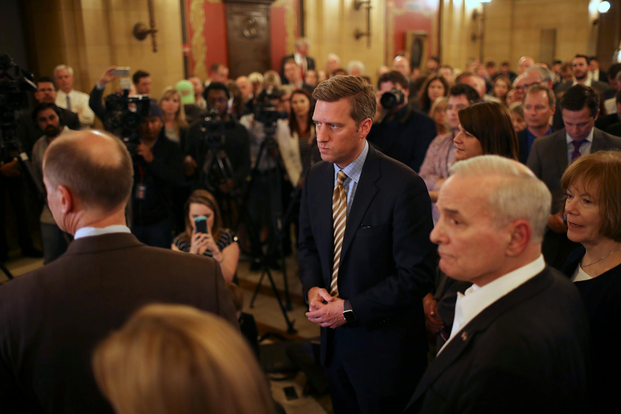 Rep. Kurt Daudt, Speaker of the House, center, after he and the leadership announced that an agreement had been reached between them and the Governor, right, to convene a special session at 12:01 a.m. Tuesday to take on the outstanding budget bills and the tax bill. With Daudt was Senator Paul Gazelka, Senate Majority Leader, left, and Lt. Governor Tina Smith, right.