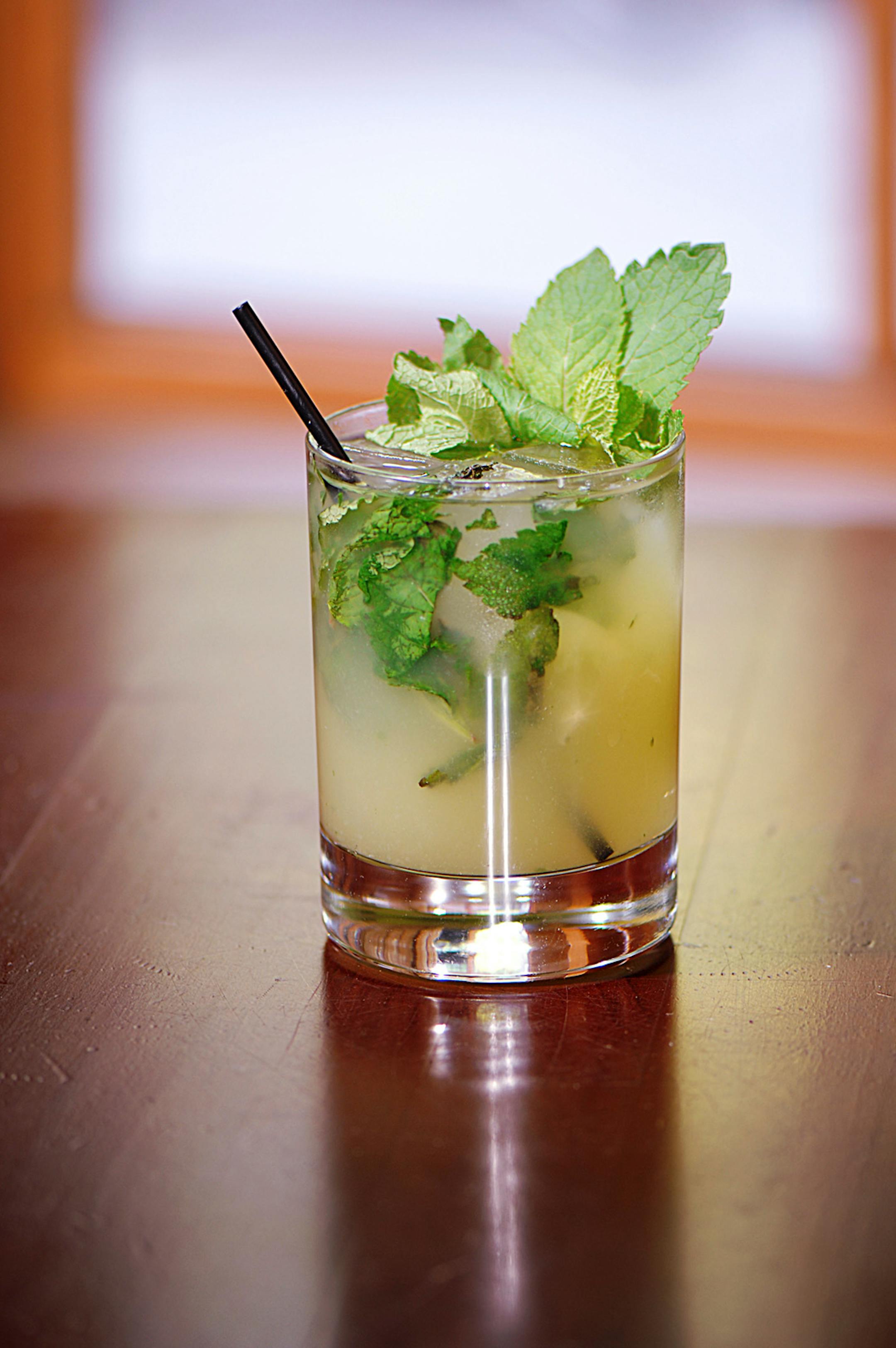 The Lucid cooler features Lucid Absinthe, St.-Germain Elderflower Liqueur, simple syrup, fresh lime, ginger ale, basil leaves and grapes as a garnish.