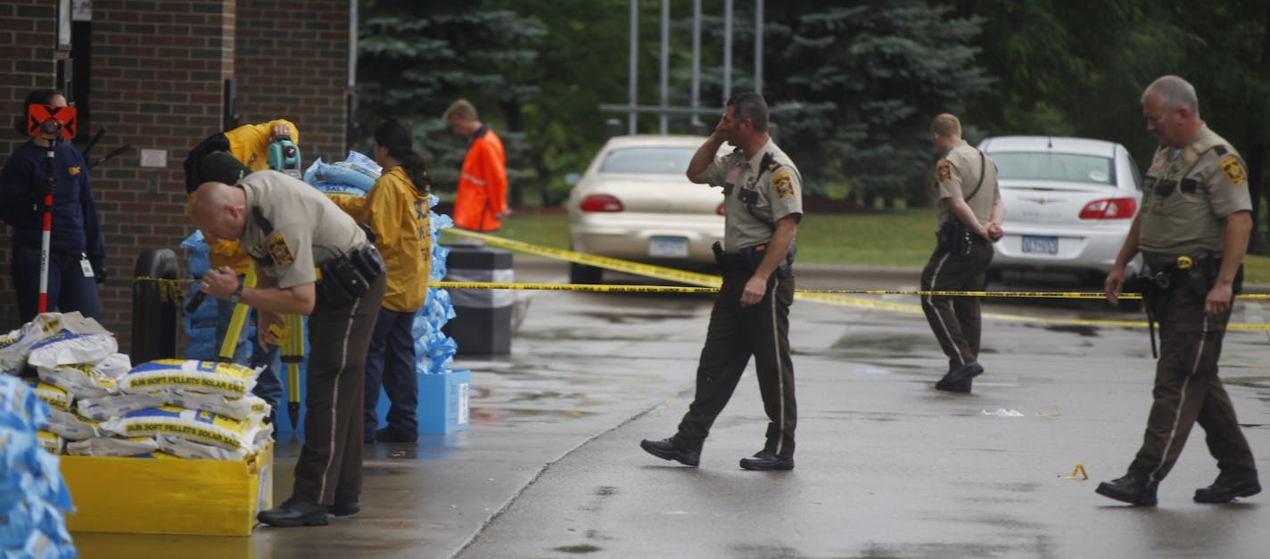 At the Holiday gas startion on Hwy. 96 near the the 35W exit in Arden Hills on Aug. 11, 2104, investigators searched for evidence in a fatal shooting.