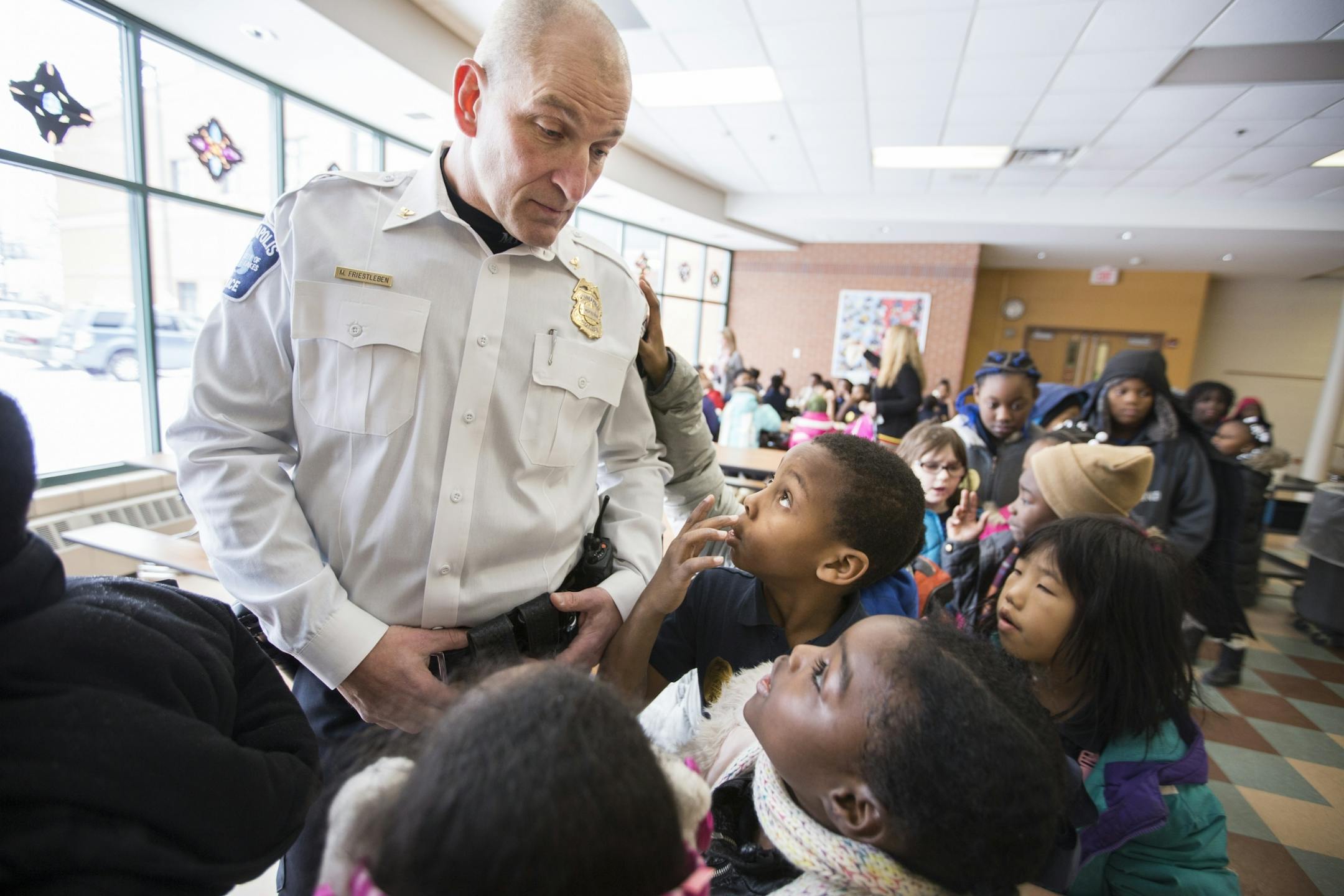 Inspector Mike Friestleben of the Minneapolis Police Department's Fourth Precinct lines up with third graders during lunch at Lucy Craft Laney Community School in Minneapolis for lunch on Thursday, February 4, 2016.