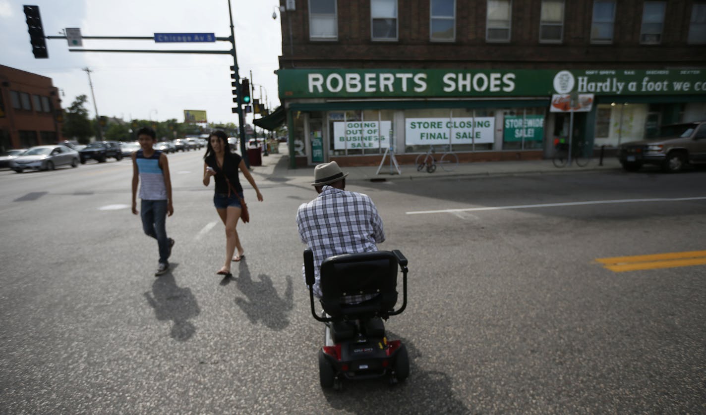 Robert Scott a customer at Roberts for many years, made his away across Chicago Avenue to shop at the store Monday August 4 , 2014 in Minneapolis , MN . Roberts Shoe store a mainstay at Chicago and Lake street is is closing after 77 years .] Jerry Holt Jerry.holt@startribune.com