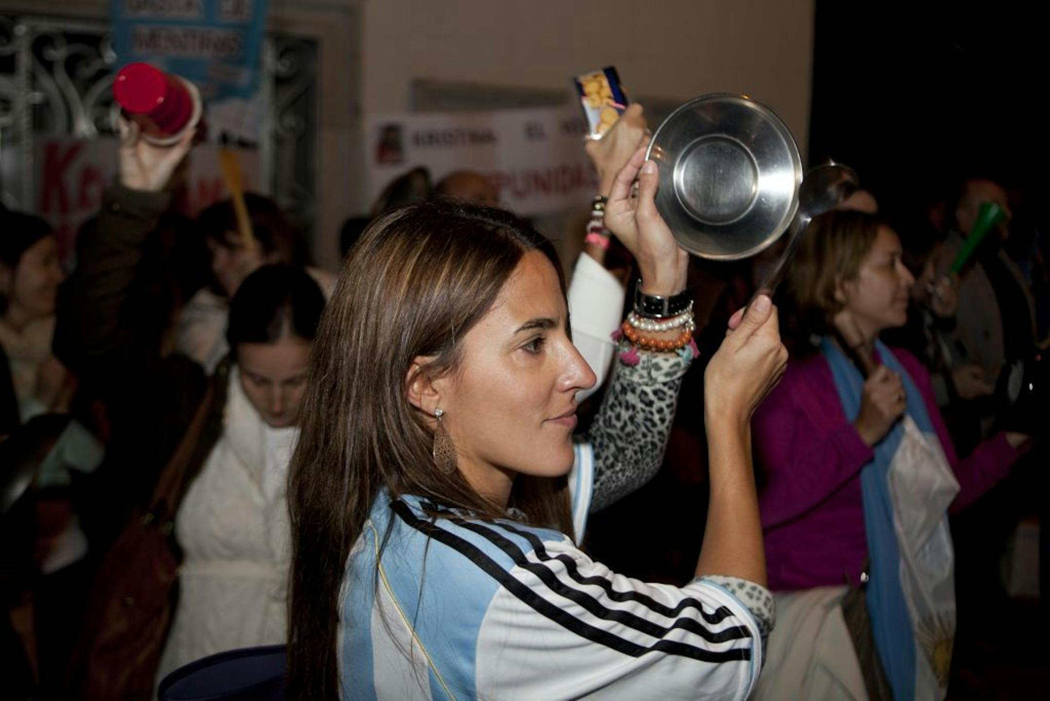 A woman wearing an Argentina's national soccer team jersey bangs a pot during a protest against Argentina's President Cristina Fernandez outside the Argentinean Consulate in Mexico City, Thursday Nov. 8, 2012. Angered by rising inflation, violent crime and high-profile corruption, and afraid Fernandez will try to hold onto power indefinitely by ending constitutional term limits, protesters banged pots and marched in Argentina's capital, Buenos Aires, in plazas nationwide, and outside Argentine e
