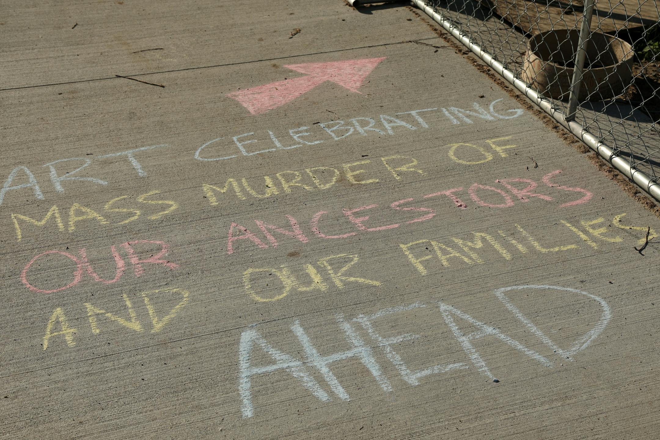 Messages scribed in chalk on the sidewalk in response to "Scaffold" by Sam Durant, which depicts the 1867 hangings of 38 Dakota men, at the Minneapolis Sculpture Garden.