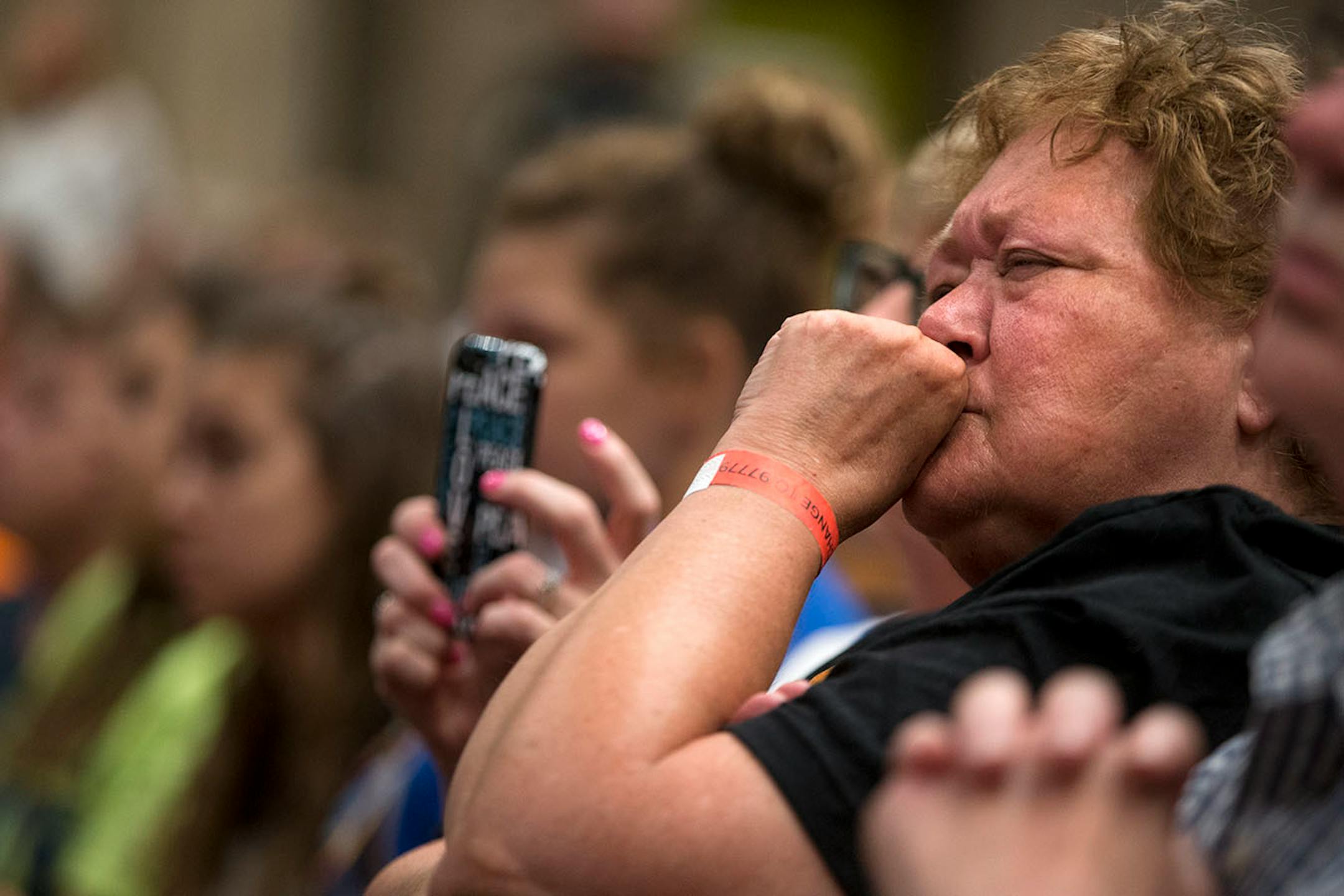 An audience member has an emotional reaction to the stories shared by students on the panel.