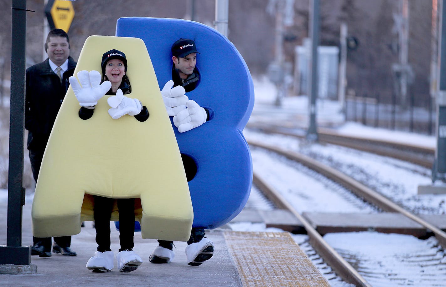 Metro Tansit's Jessica Cross, left, and Adam Mehl, greeted passengers as they made their way onto the Blue Line train from the 46th Street Station, Thursday, February 5, 2015. The Blue Line reached the 10 million rider mark and celebrated with a social media give away. ] (ELIZABETH FLORES/STAR TRIBUNE) ELIZABETH FLORES &#x2022; eflores@startribune.com