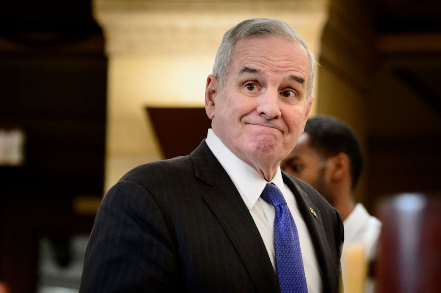 Governor Dayton smiled as he entered the press conference to talk about the budget surplus.