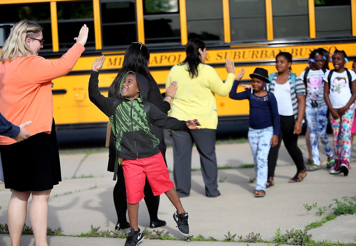 Teachers greeted scholars with high-fives as they arrived to the Northside Achievement Zone (NAZ) summer school program at City View School, Tuesday, 