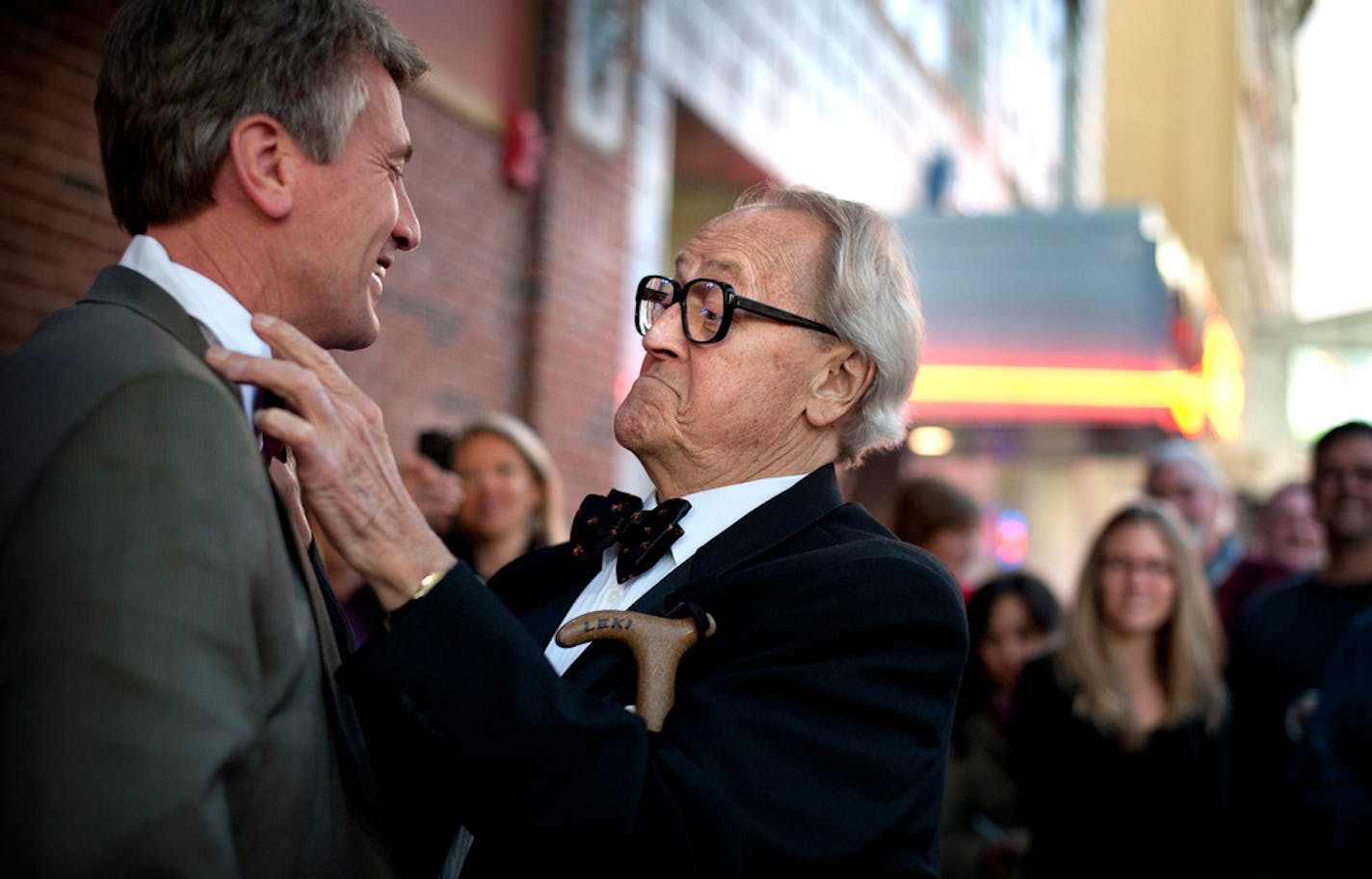 Dudley Riggs, founder of Brave New Workshop, helped Mayor R.T. Rybak put on a bow tie to match Dudley's signature bow tie in November 2011. The Theater commemorated its move from Uptown to new location on Hennepin Ave with an opening night marquee-lighting ceremony.