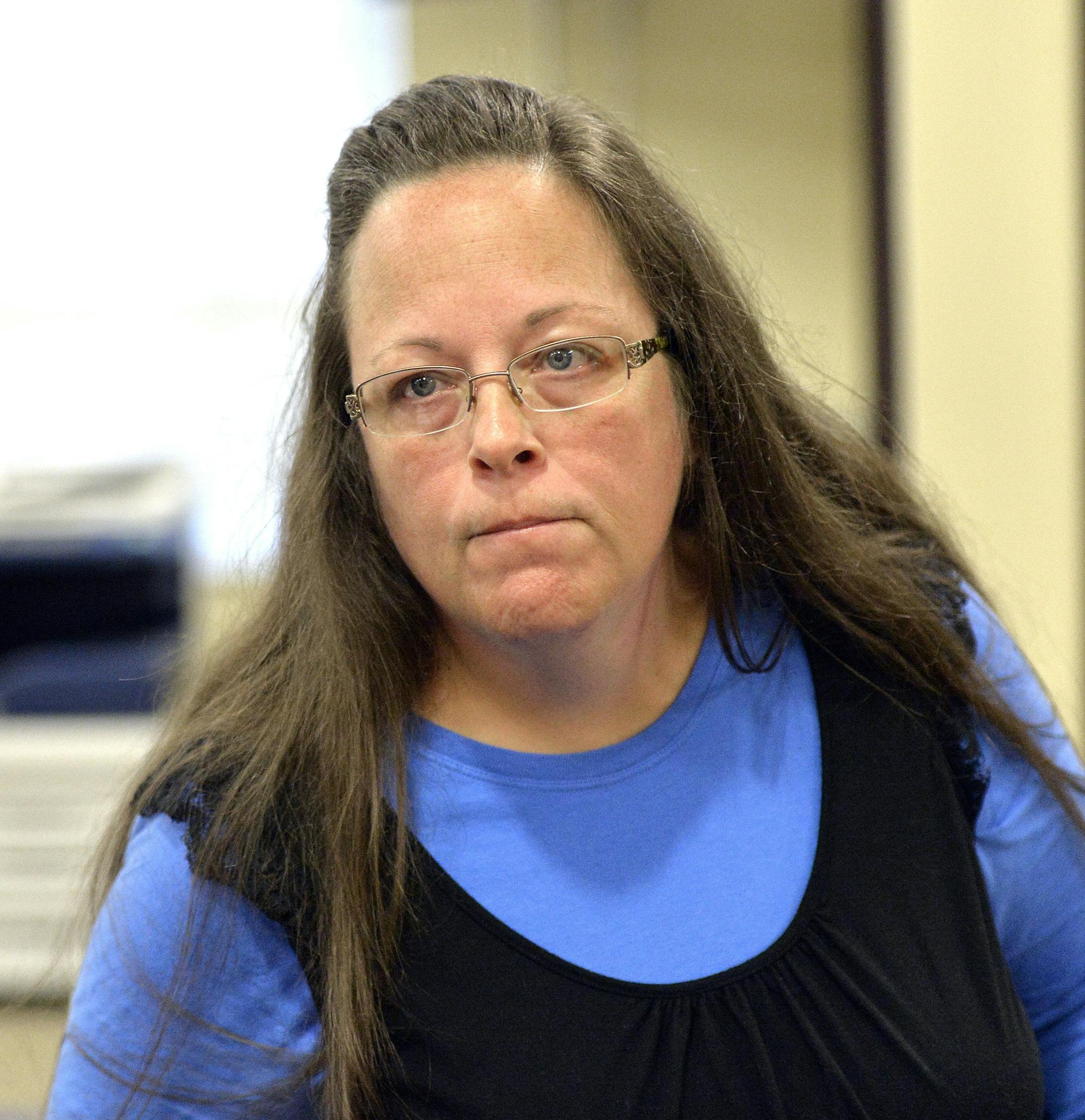 Rowan County Clerk Kim Davis listens to a customer following her office's refusal to issue marriage licenses at the Rowan County Courthouse in Morehead, Ky., Tuesday, Sept. 1, 2015. Although her appeal to the U.S. Supreme Court was denied, Davis still refuses to issue marriage licenses. (AP Photo/Timothy D. Easley)