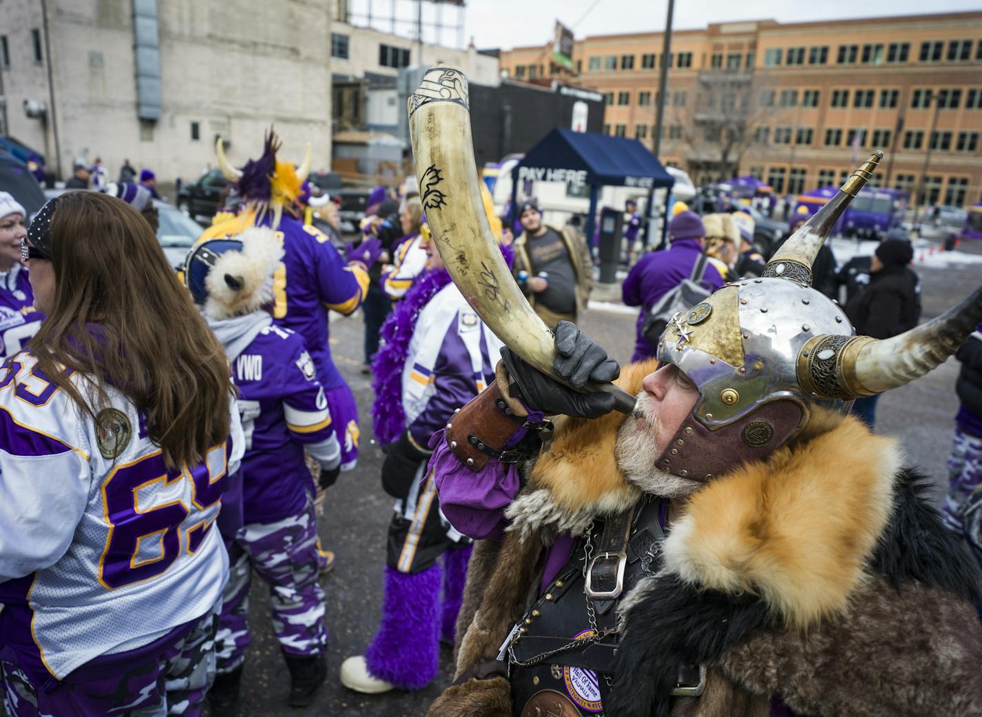 Greg Hanson blows his horn as part of his persona as the Norse god Odin. He likes to be known as "Sir Odin."