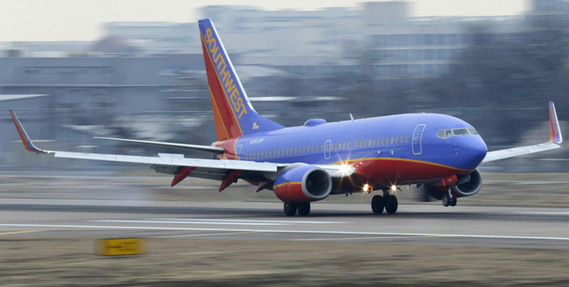 File - In this Feb. 3, 2014 file photo, a Southwest Airlines jet plane lands at Love Field in Dallas. Southwest Airlines is falling behind other airlines when it comes to arriving on time, and the carrier plans to tinker with its flight schedule to fix that. (AP Photo/LM Otero, File)