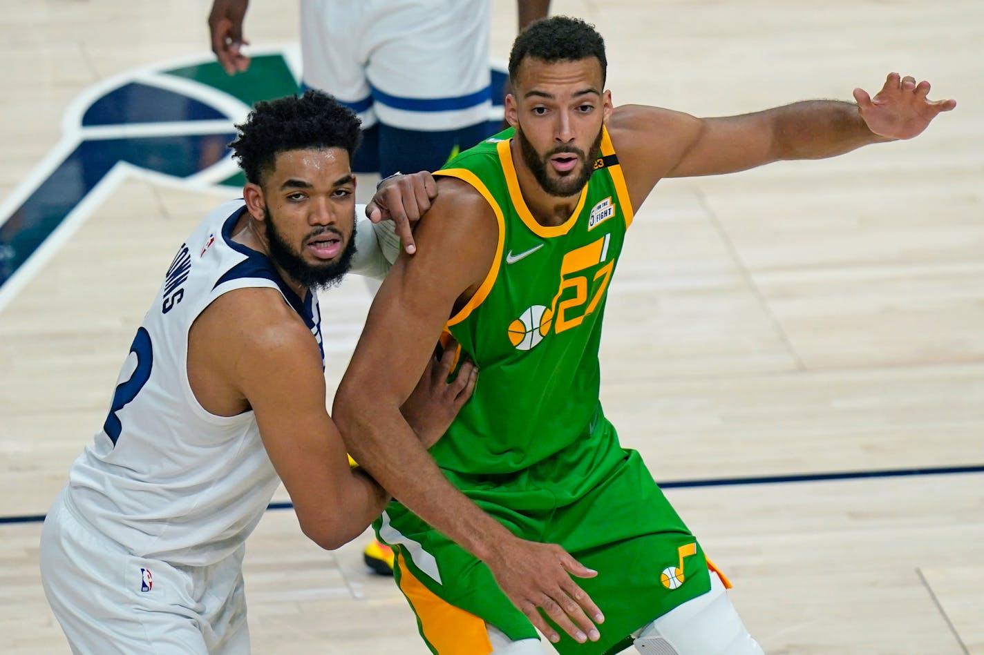 Minnesota Timberwolves center Karl-Anthony Towns, left, guards Utah Jazz center Rudy Gobert (27) in the first half during an NBA basketball game Saturday, April 24, 2021, in Salt Lake City. (AP Photo/Rick Bowmer) ORG XMIT: UTRB112