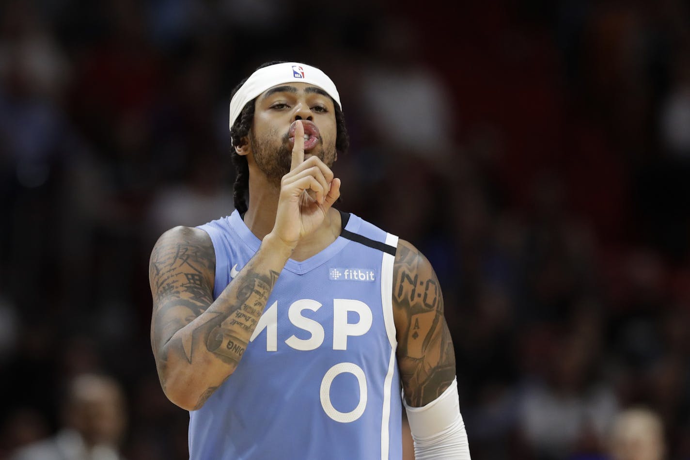 Minnesota Timberwolves guard D'Angelo Russell gestures to the crowd after scoring during the second half of the team's NBA basketball game against the Miami Heat, Wednesday, Feb. 26, 2020, in Miami. (AP Photo/Wilfredo Lee)